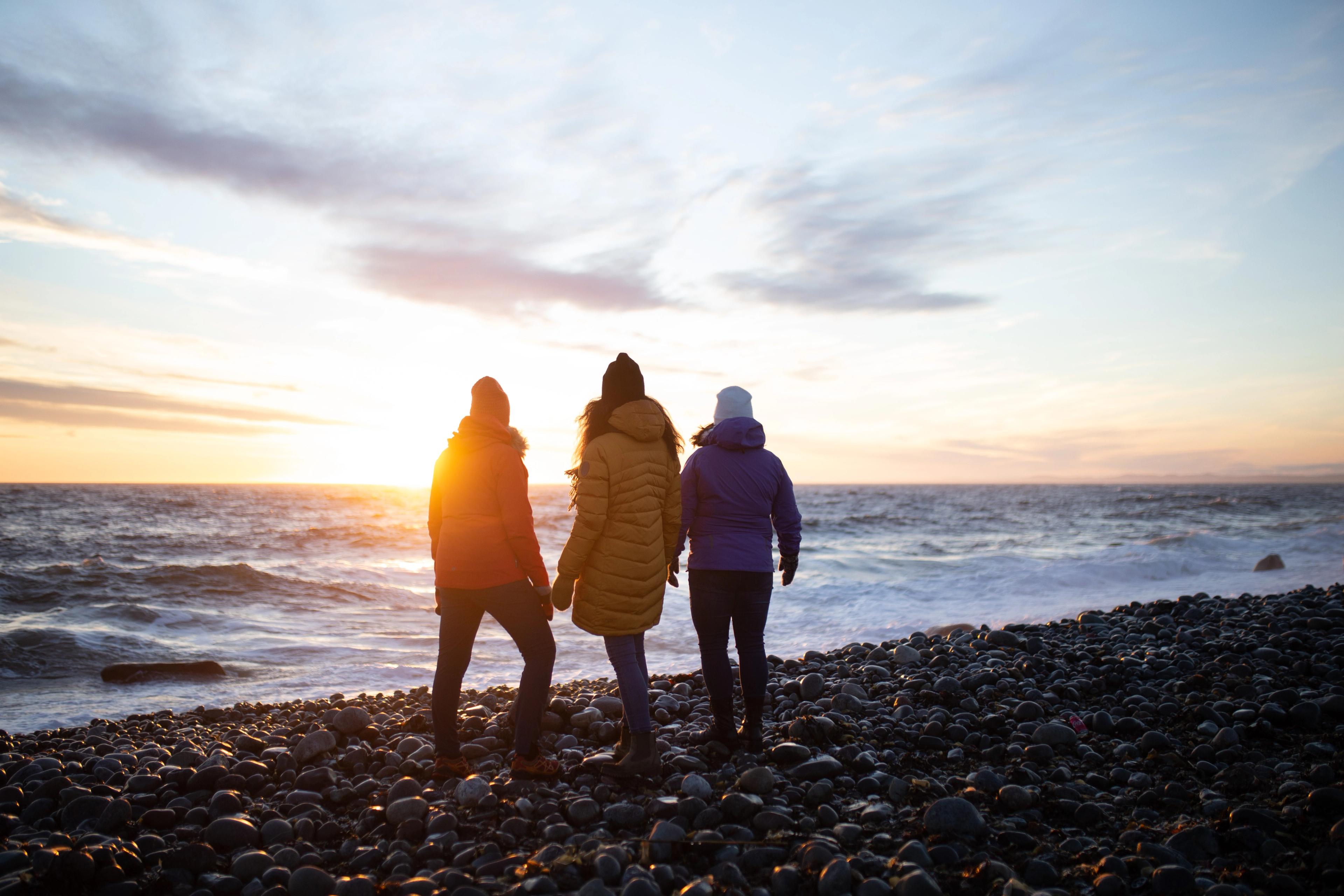 Three woman walking on the beach at Mølen, UNESCO Geo global park in Larvik