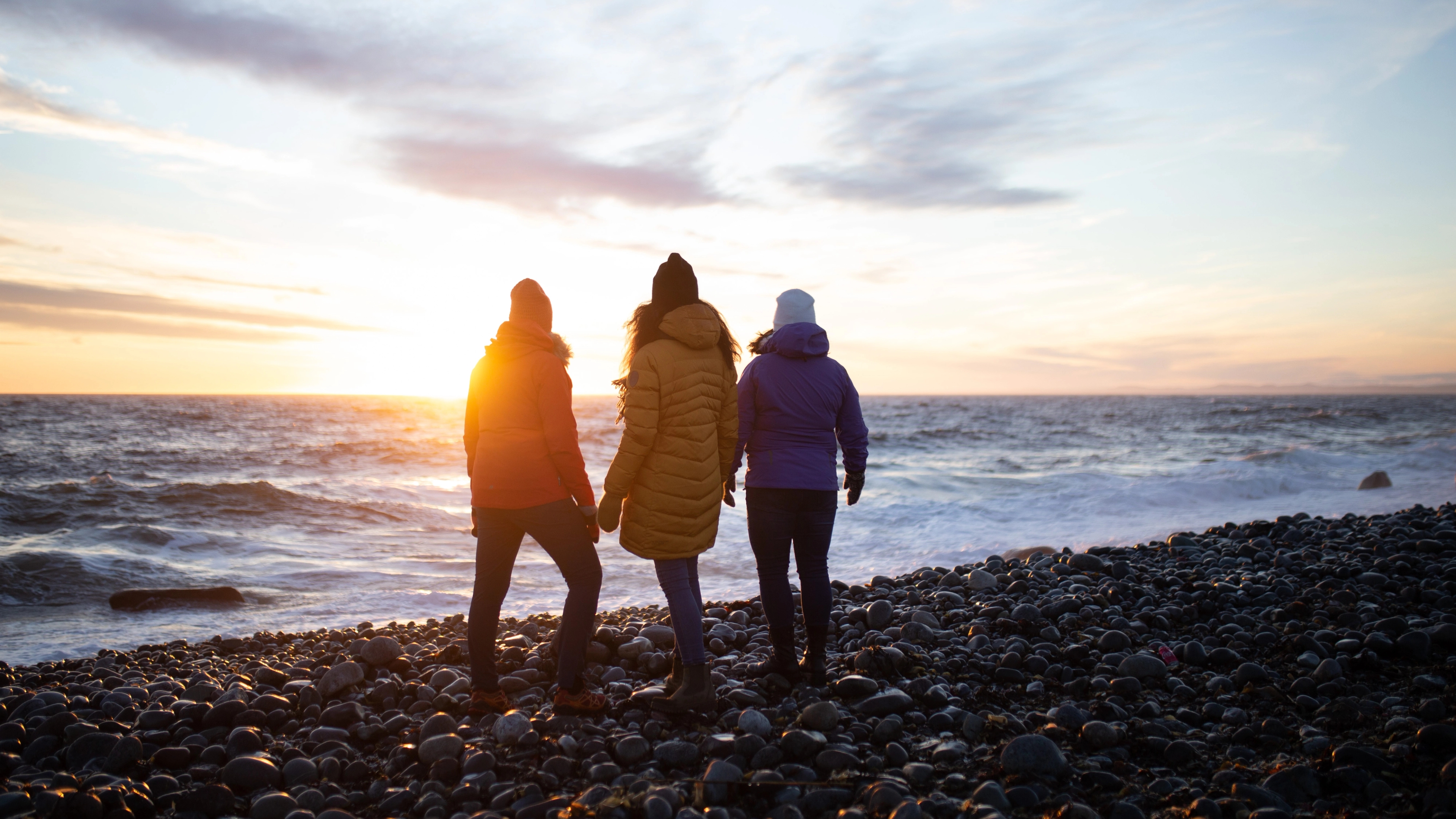 Three woman walking on the beach at Mølen, UNESCO Geo global park in Larvik