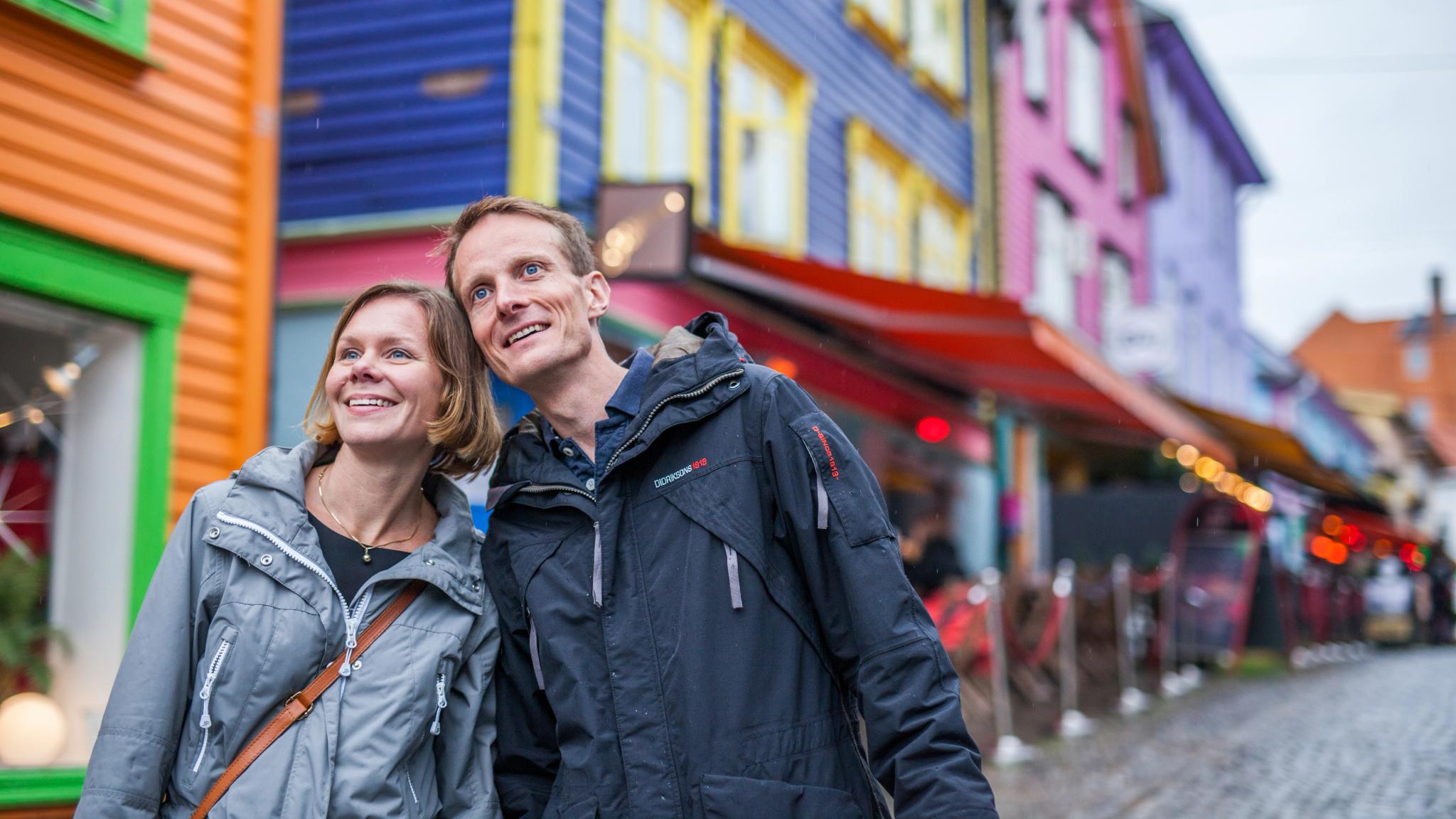 Two people on a weekend trip to Stavanger in Fjord Norway, in the colourful street Øvre Holmegate