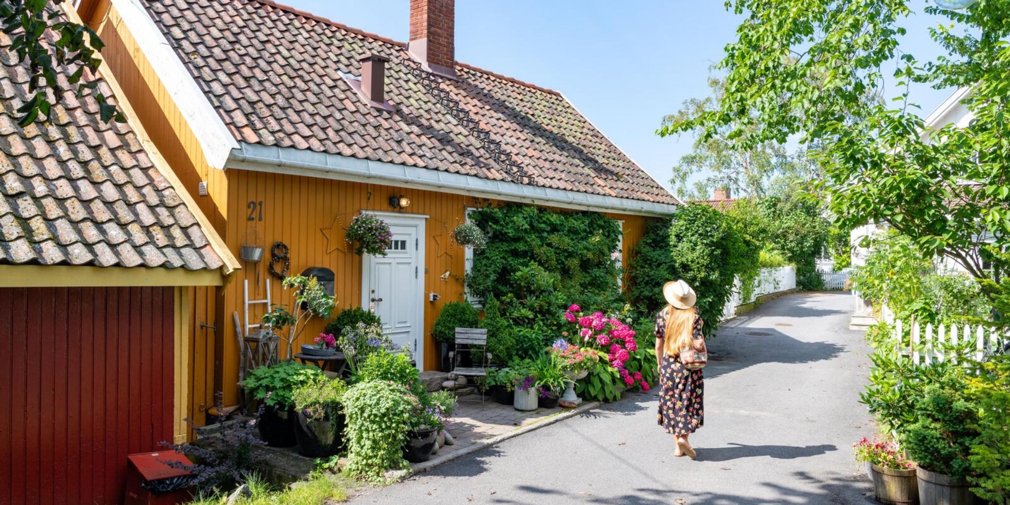 Woman walking in Badehusgata in Drøbak on a summerday, Follo