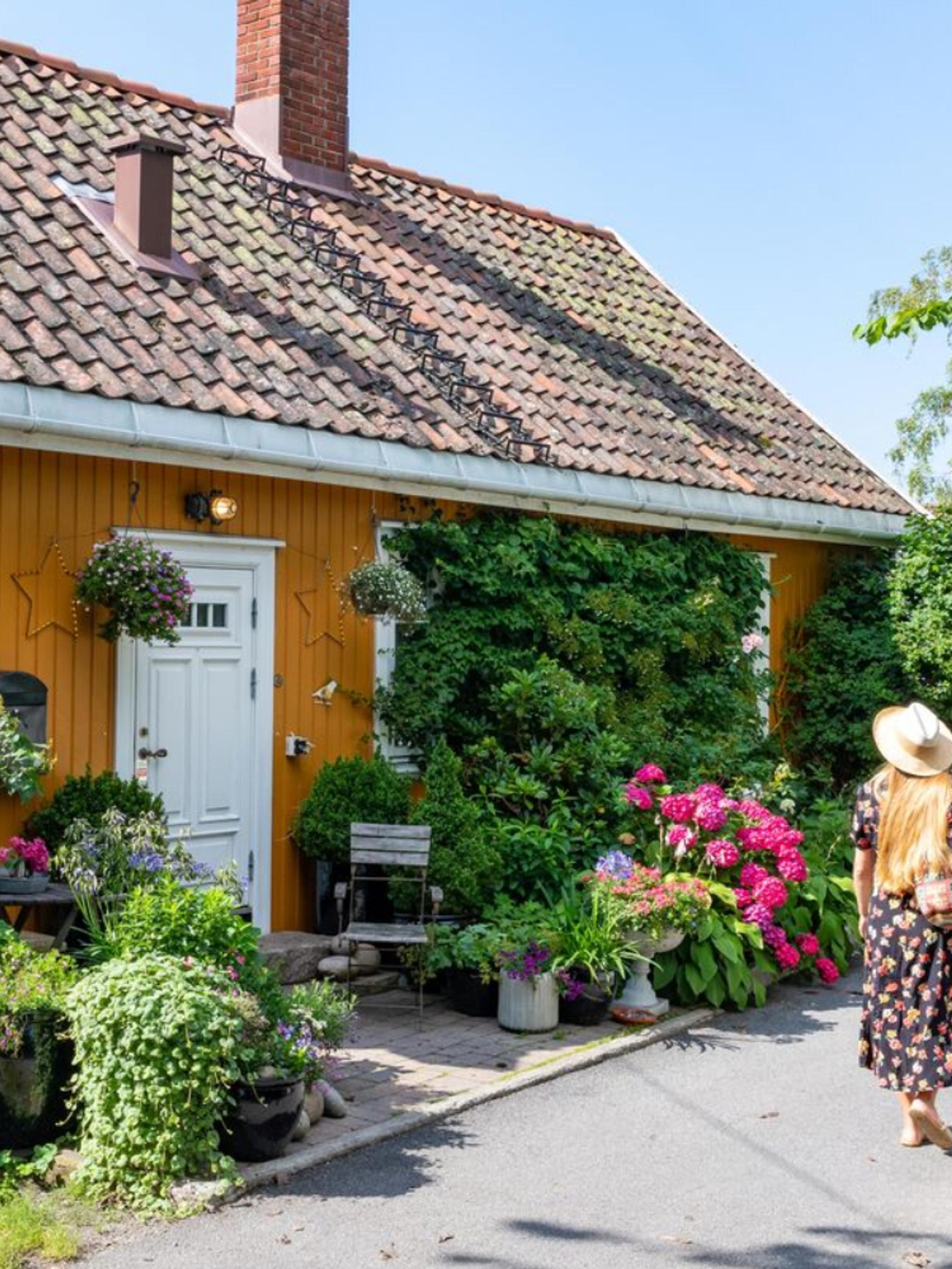 Woman walking in Badehusgata in Drøbak on a summerday, Follo