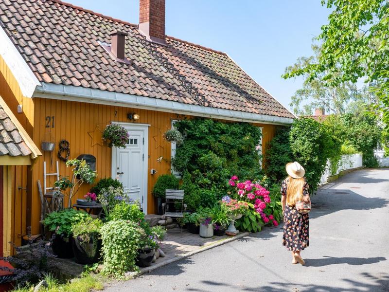 Woman walking in Badehusgata in Drøbak on a summerday, Follo