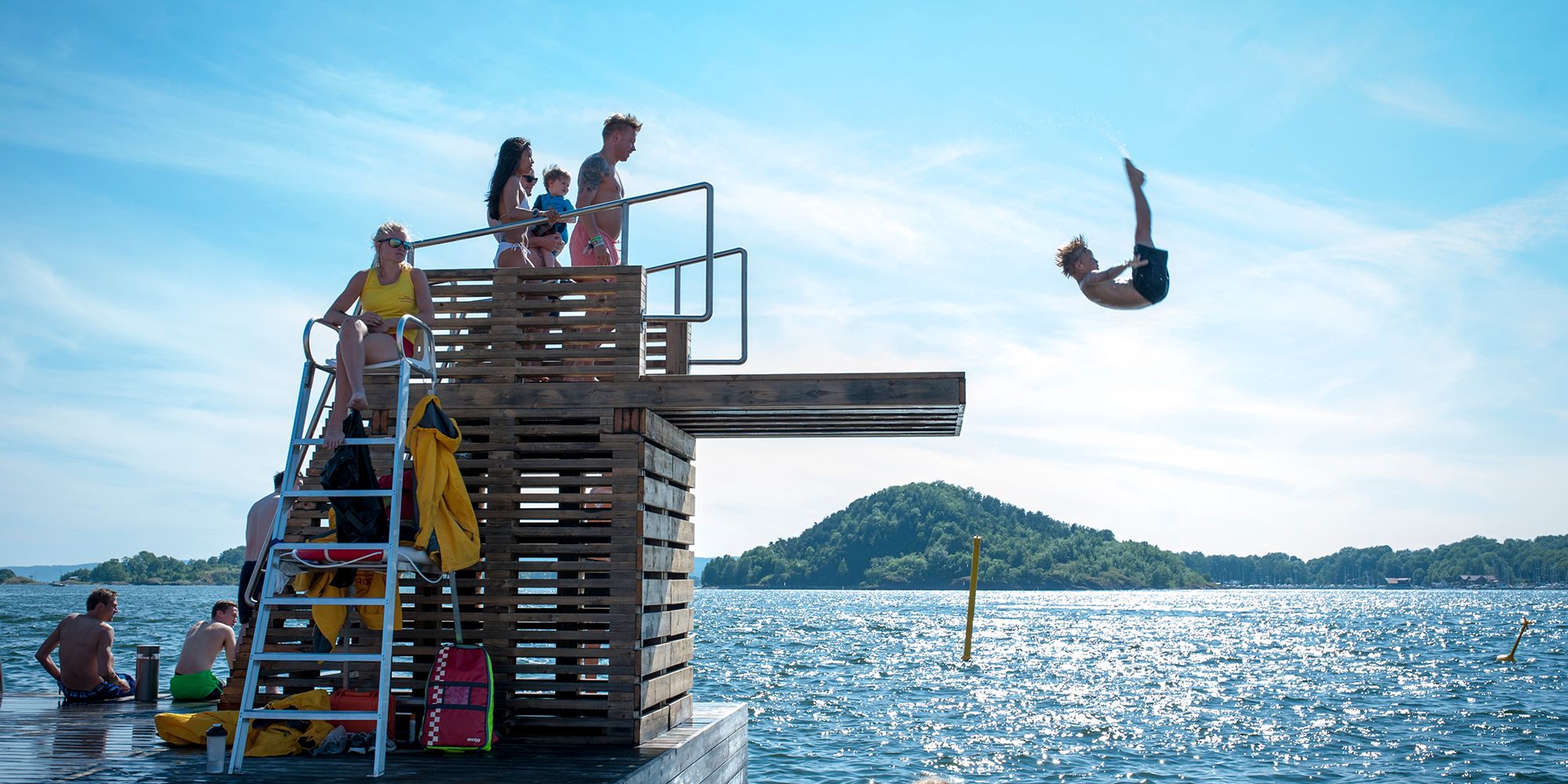 People jumping in the water at Sørenga sjøbad, Oslo, Eastern Norway