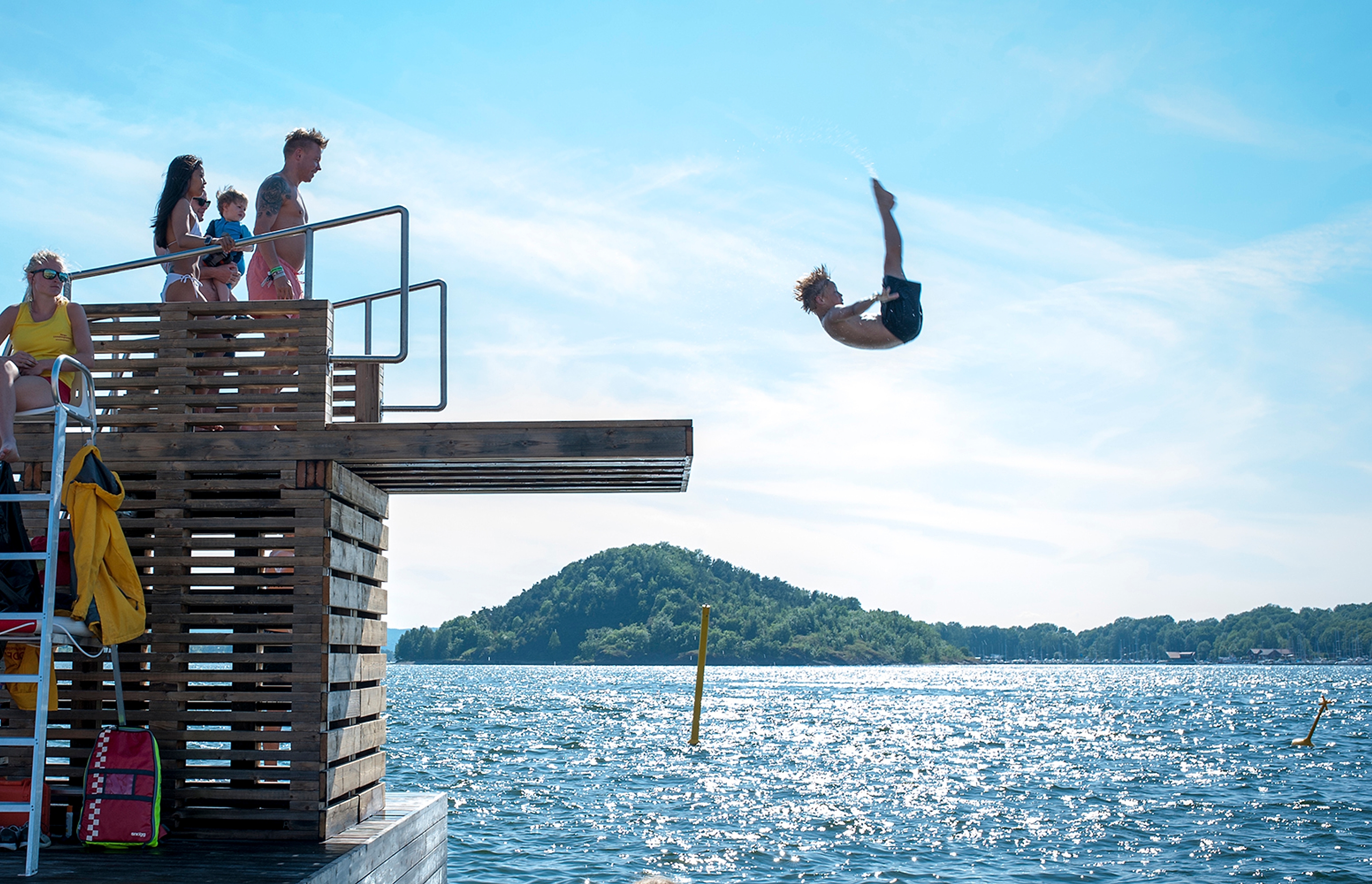 People jumping in the water at Sørenga sjøbad, Oslo, Eastern Norway