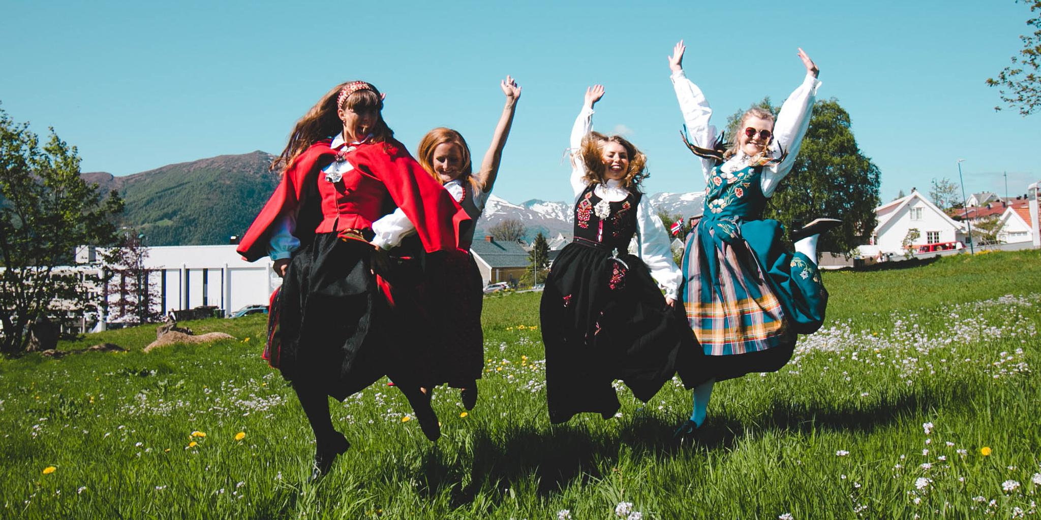 Four girls out on the field wearing bunad, the Norwegian traditional costume in Volda in Fjord Norway