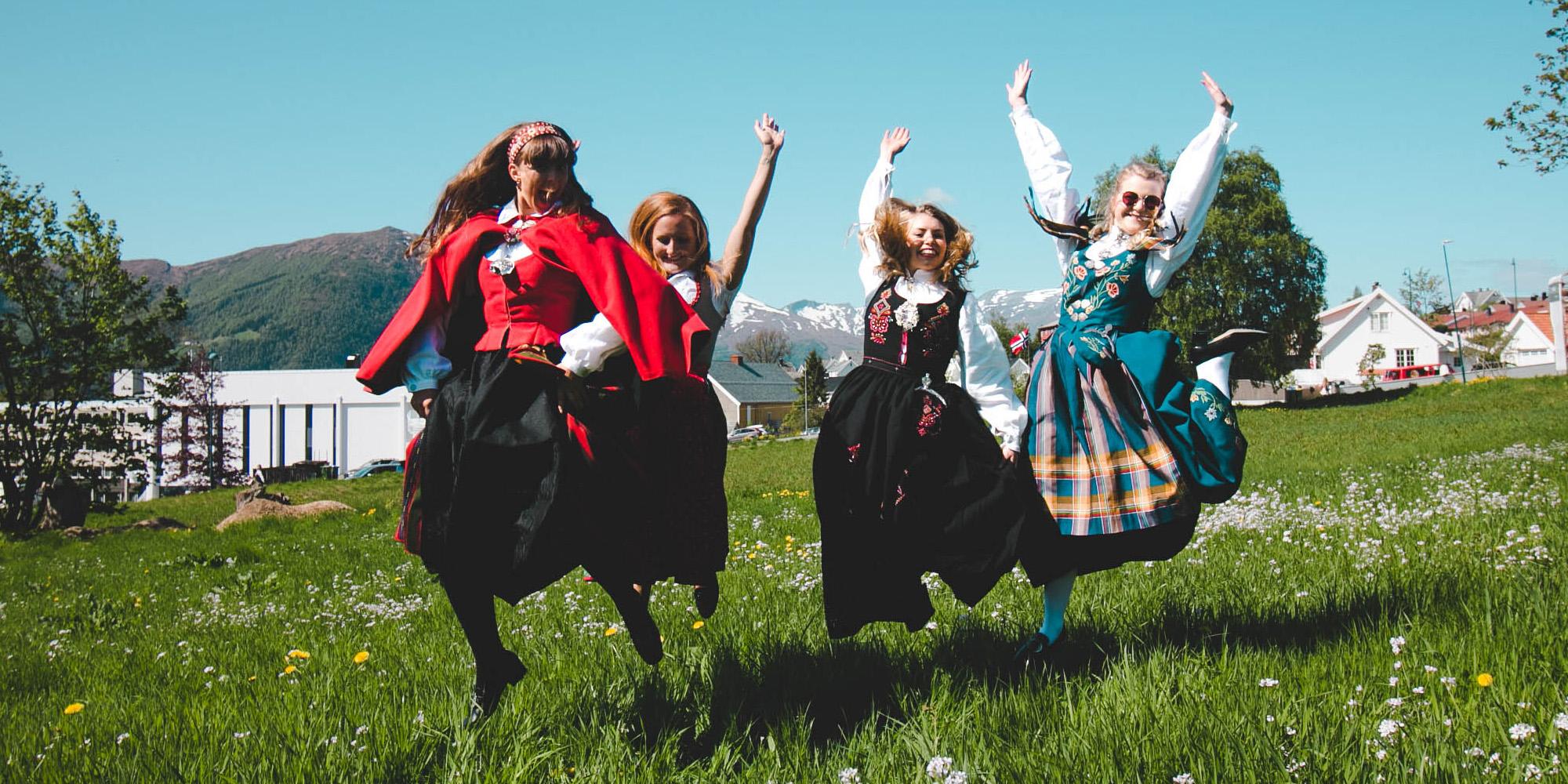 Four girls out on the field wearing bunad, the Norwegian traditional costume in Volda in Fjord Norway