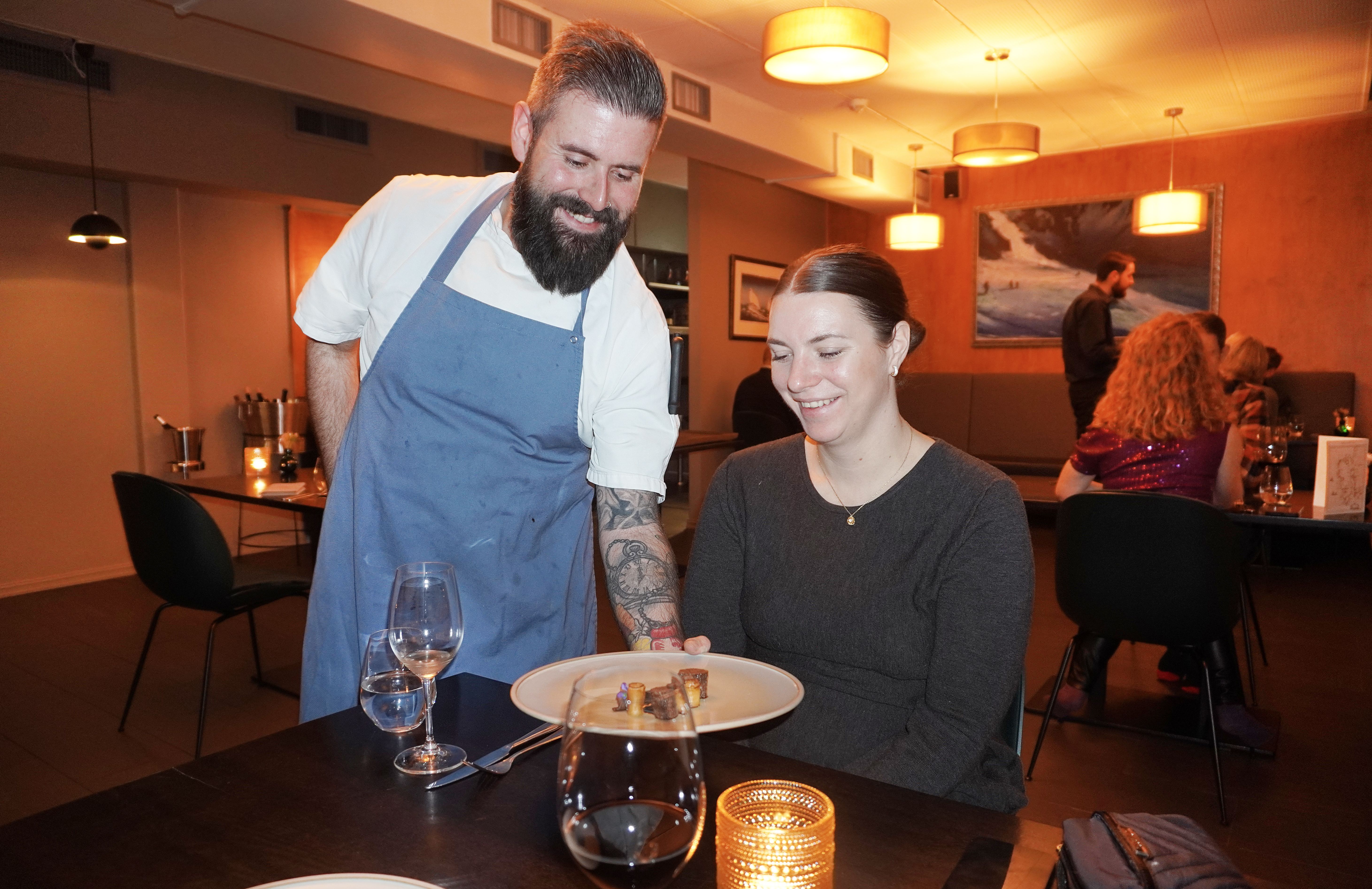 A man serving a woman