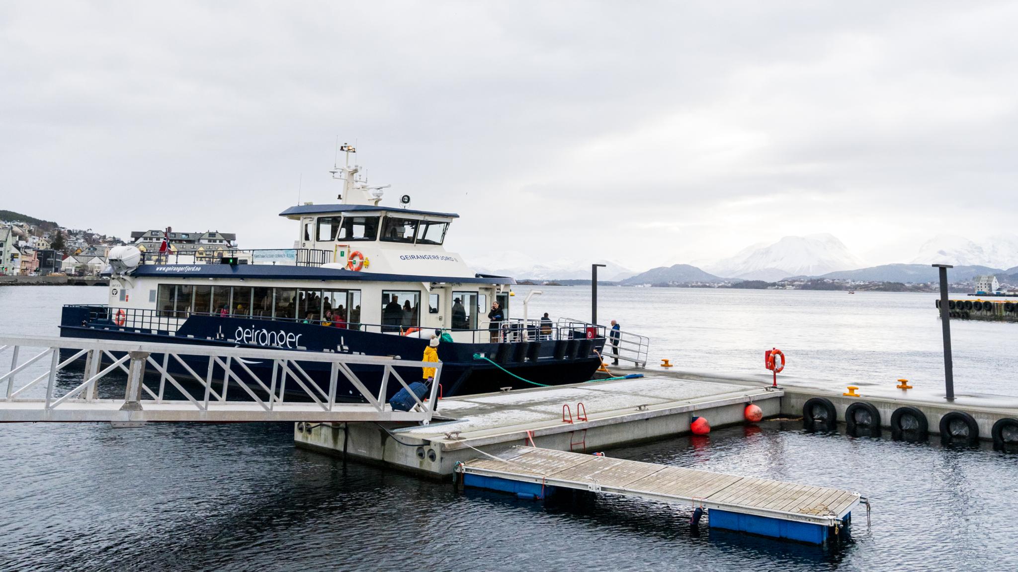 Woman entering the Geiranger Fjordservice cruise boat to Geiranger