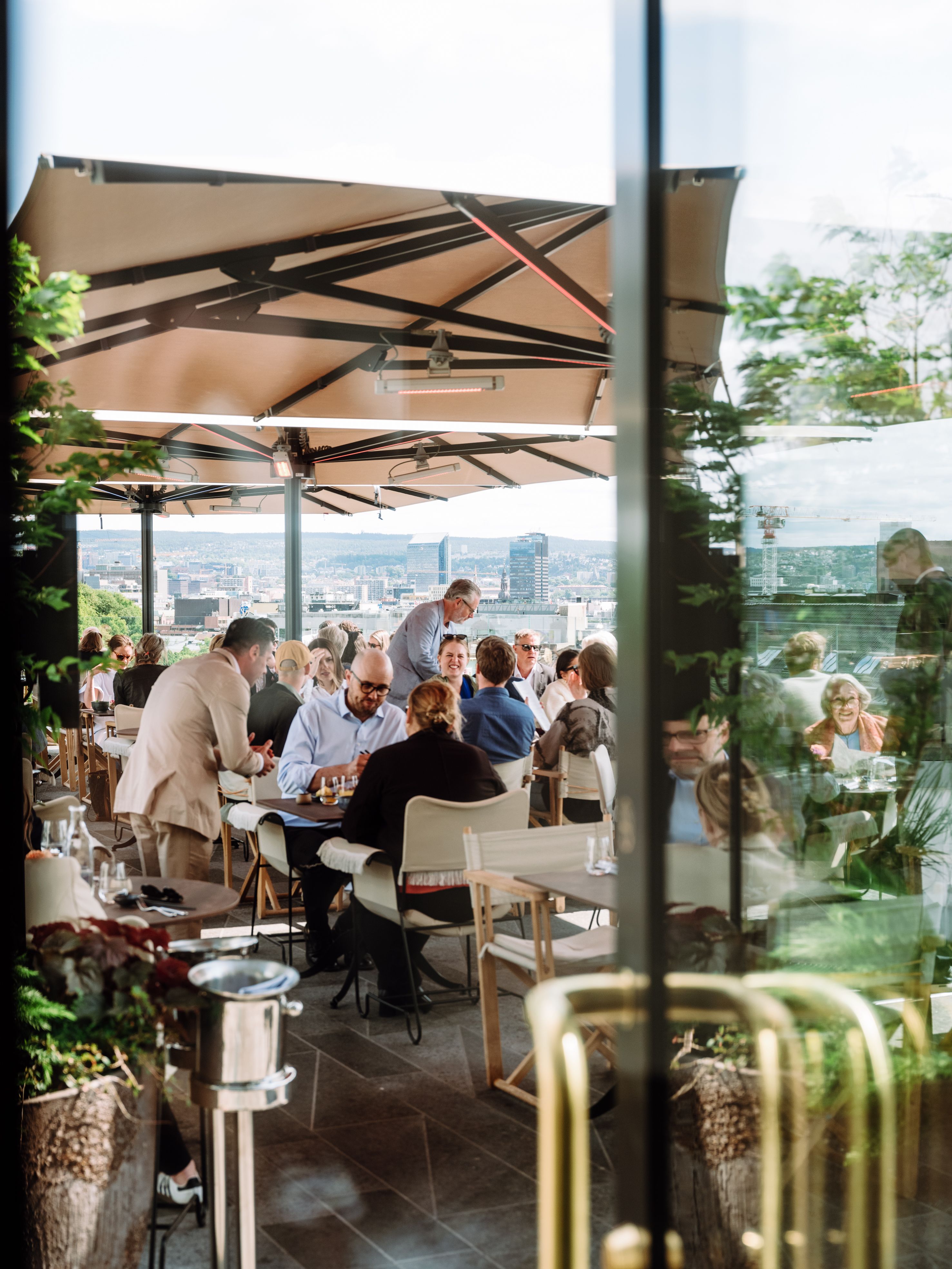 People sitting in the sun at Izakaya Bar & Terrace at Sommerro