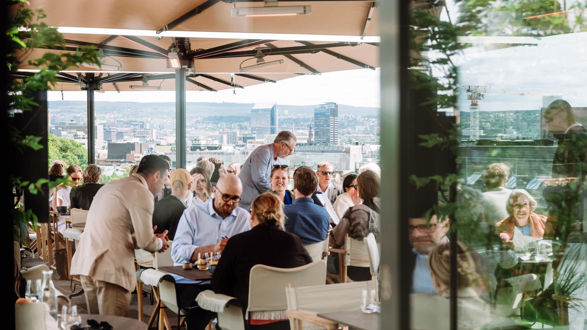 People sitting in the sun at Izakaya Bar & Terrace at Sommerro