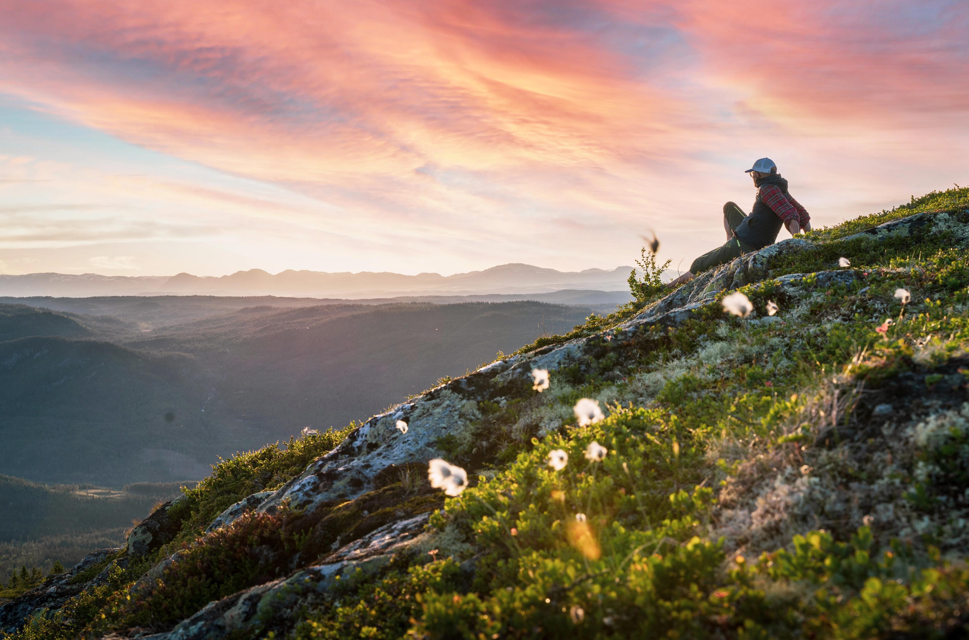 A hiker enjoying the view at Nesfjellet, Eastern Norway.