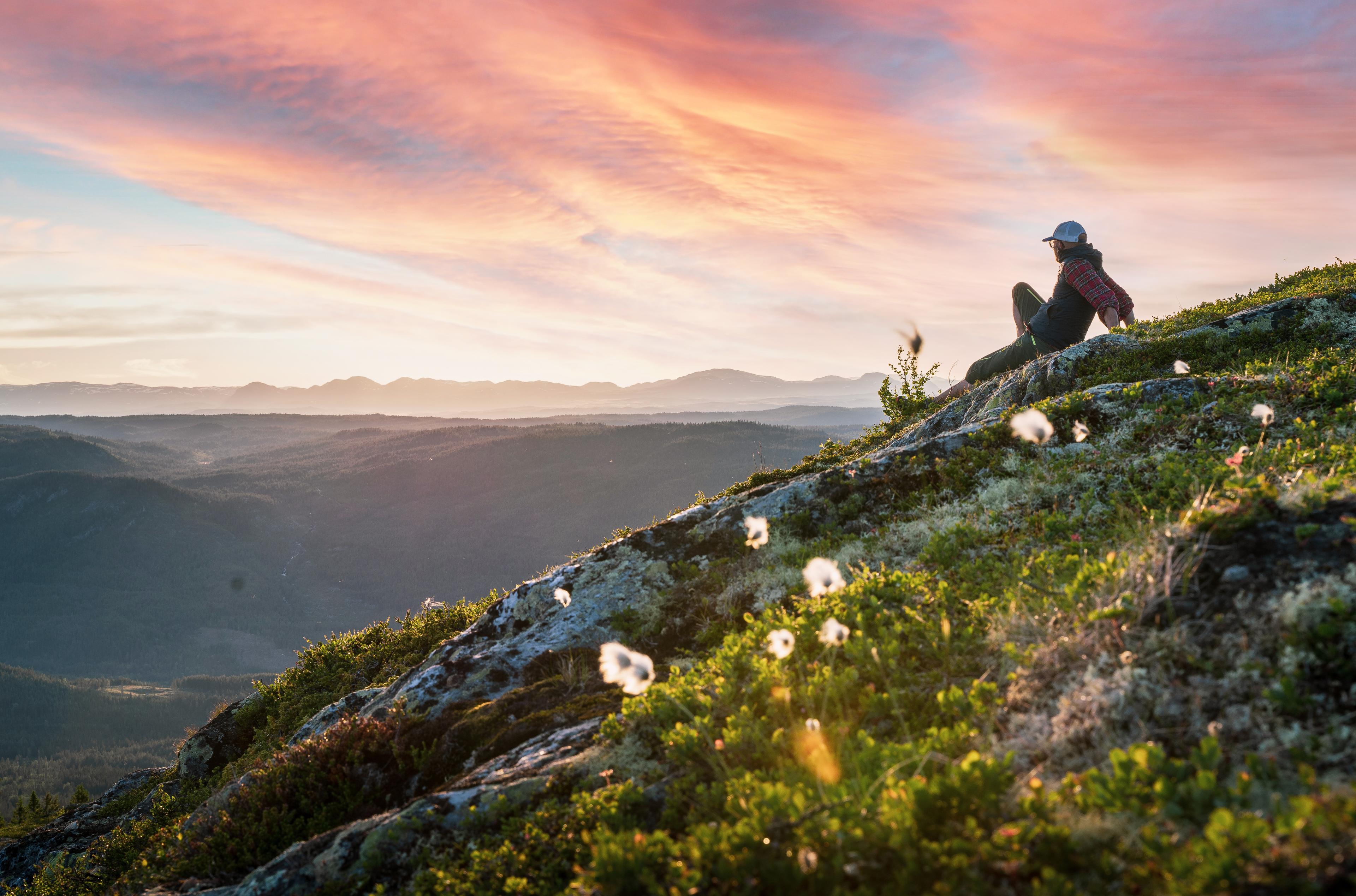 A hiker enjoying the view at Nesfjellet, Eastern Norway.