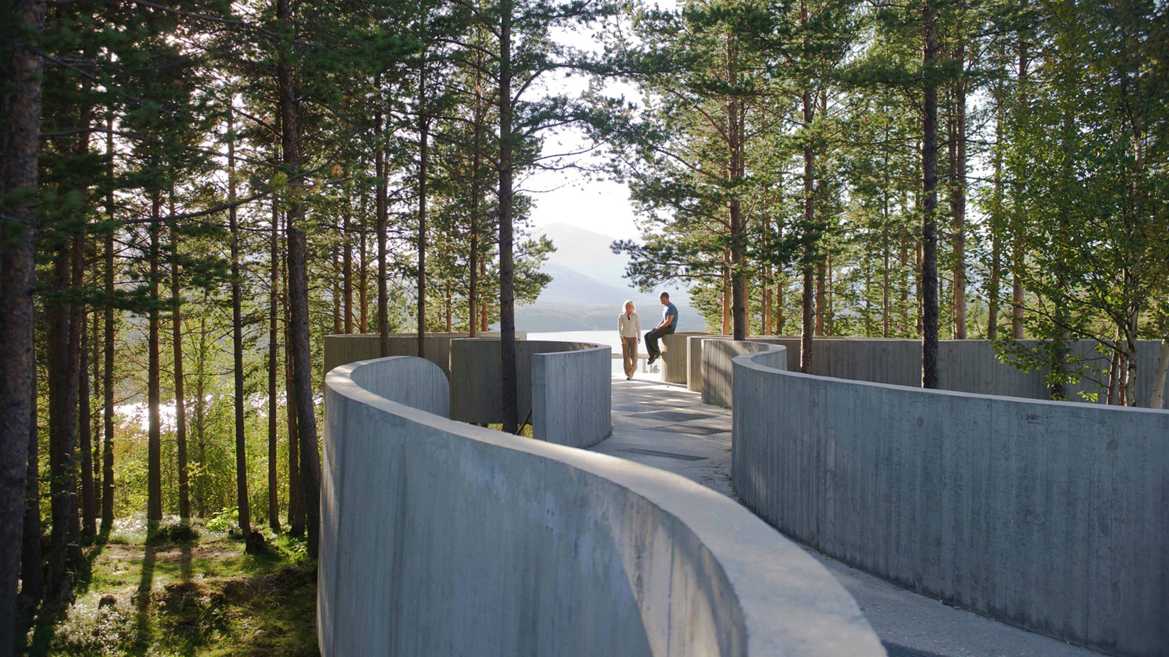 Two people at the tip of Sohlbergplassen viewpoint in Rondane, Eastern Norway.