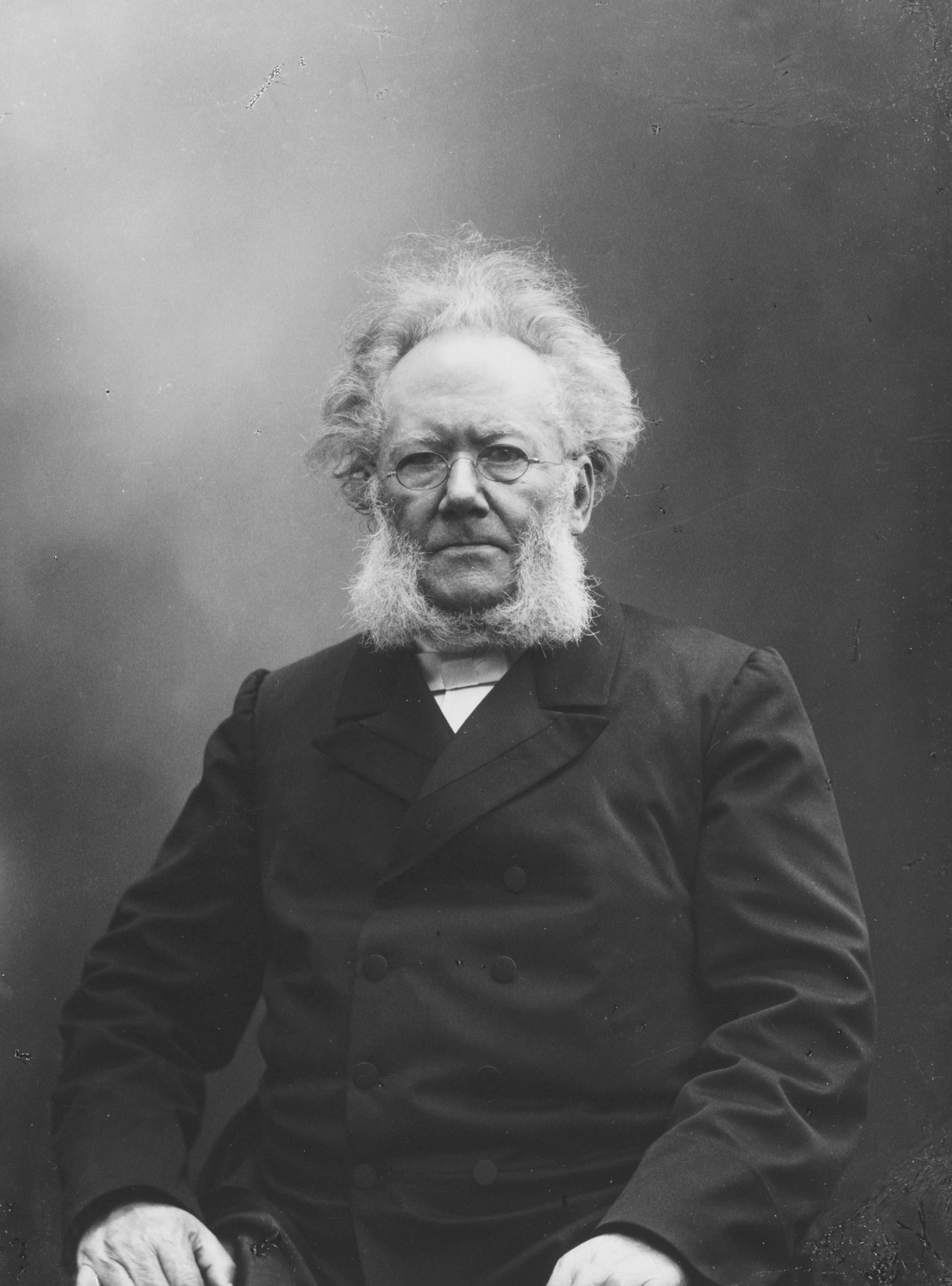 The Norwegian playwright and poet Henrik Ibsen sitting down. Black and white photo.