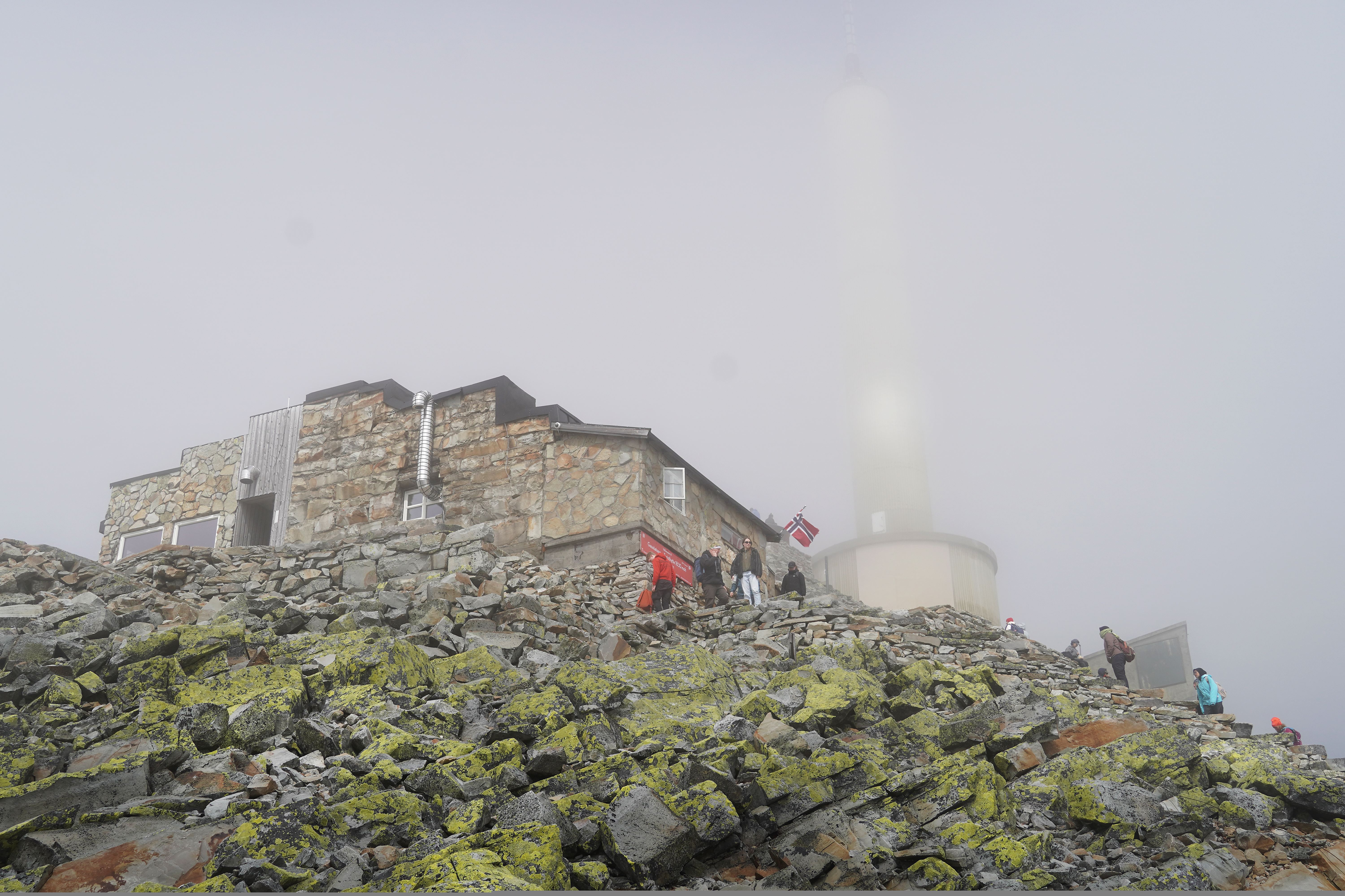 Foggy day by a stone mountain lodge