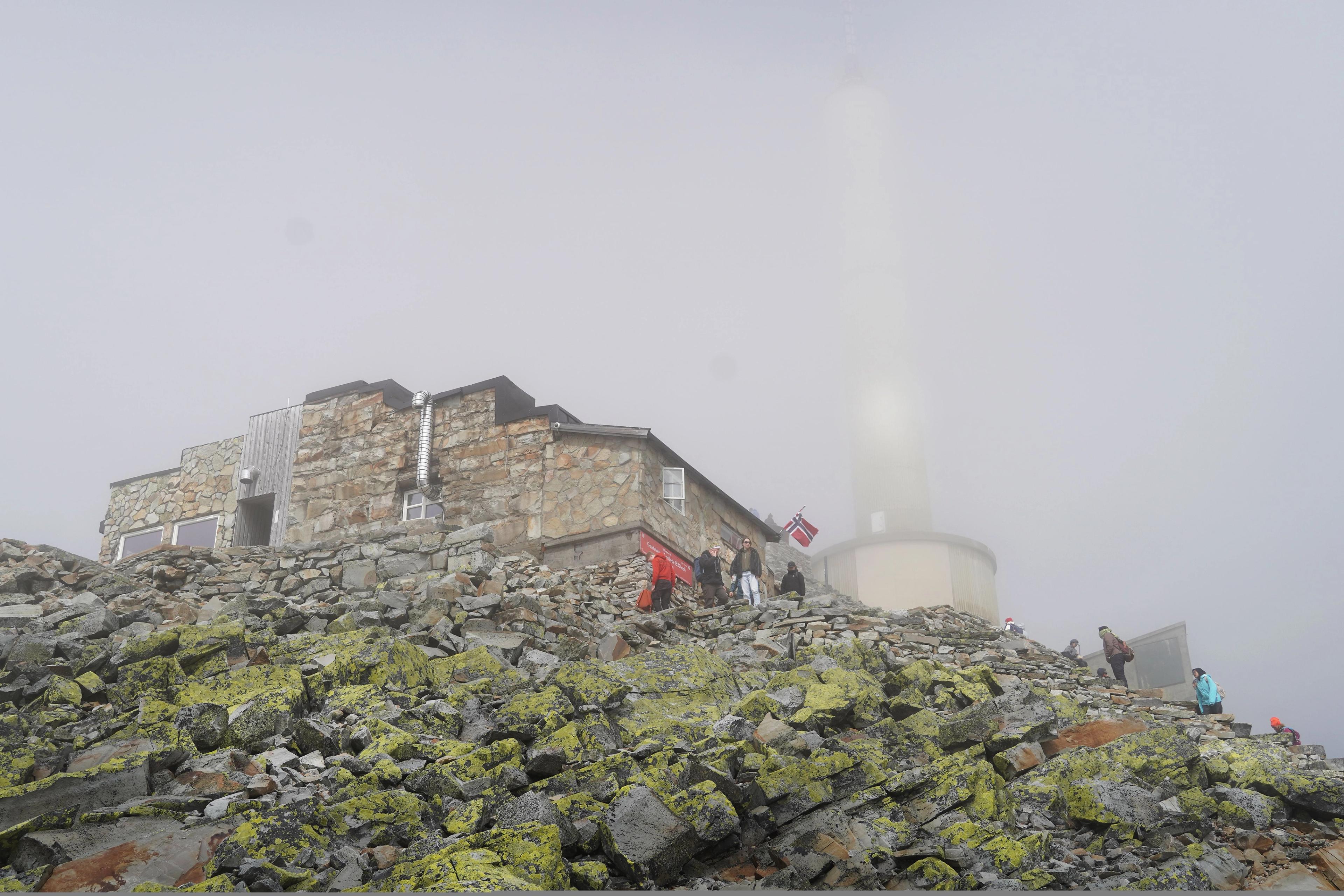 Foggy day by a stone mountain lodge