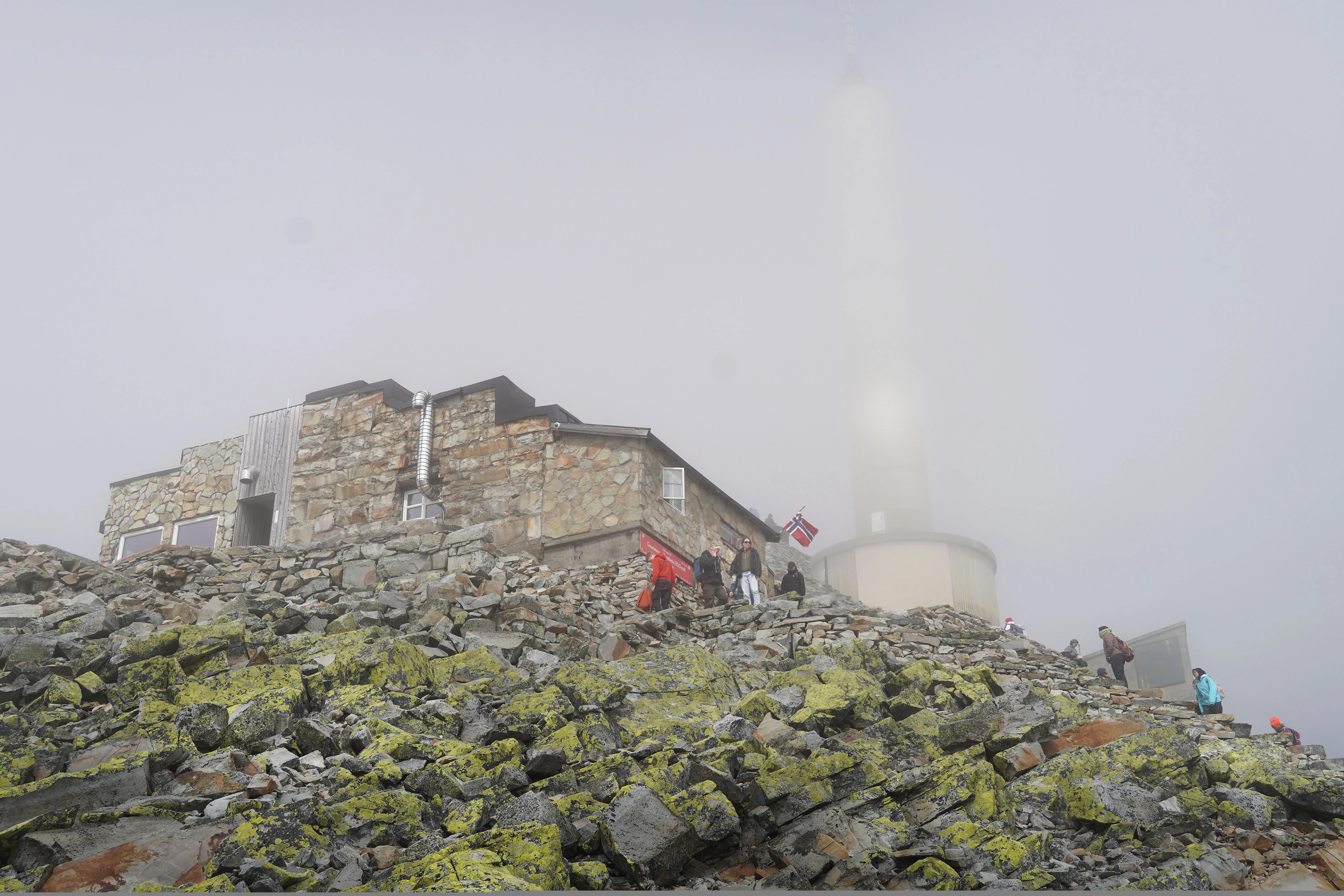 Foggy day by a stone mountain lodge