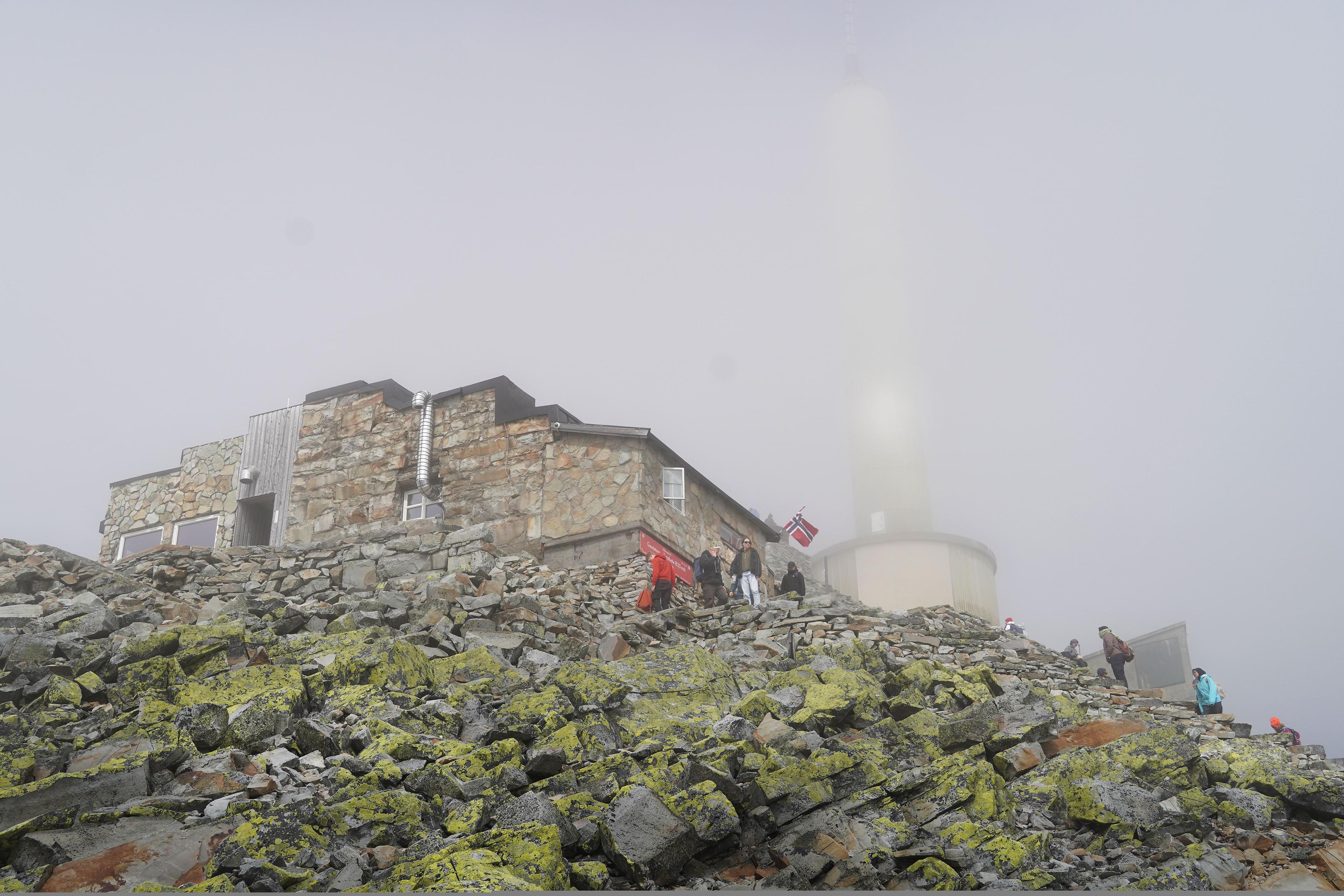 Foggy day by a stone mountain lodge