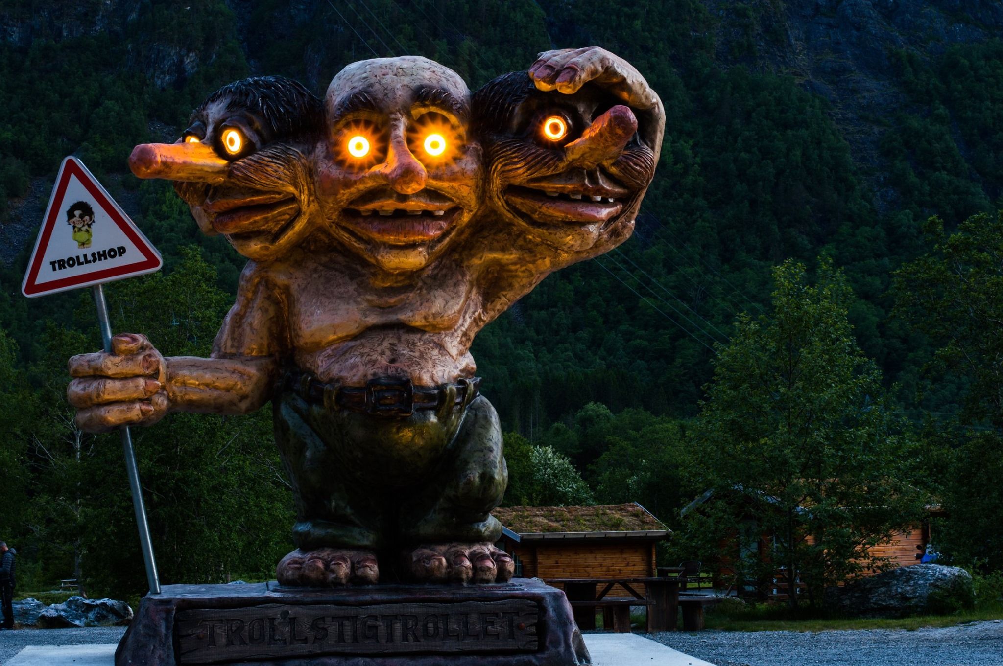 A statue of a three headed troll with lights in the eyes, Trollstigen