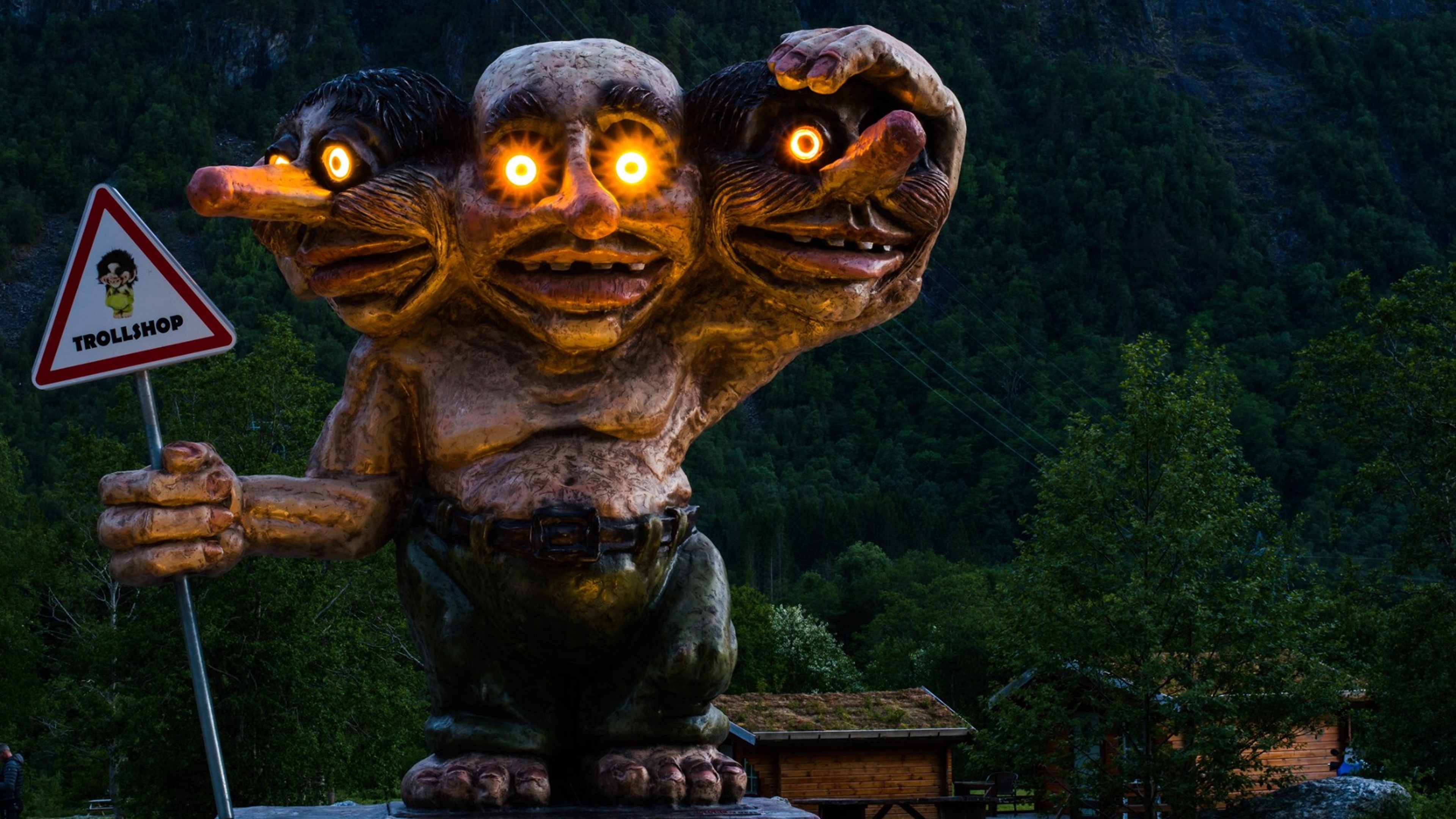 A statue of a three headed troll with lights in the eyes, Trollstigen