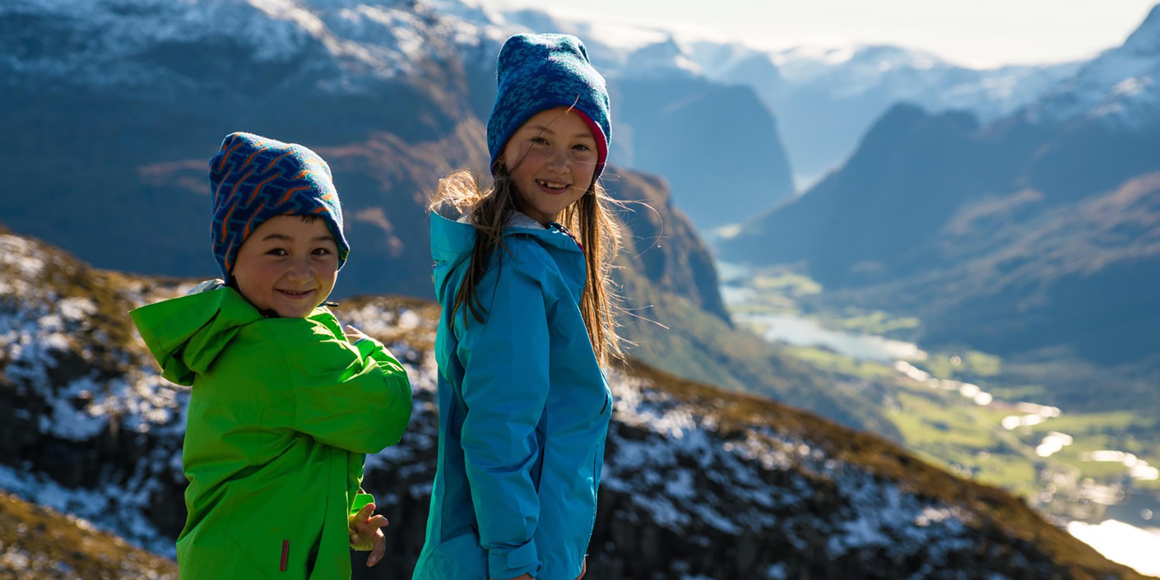 Two children are hiking in the mountains in Stryn, Fjord Norway.