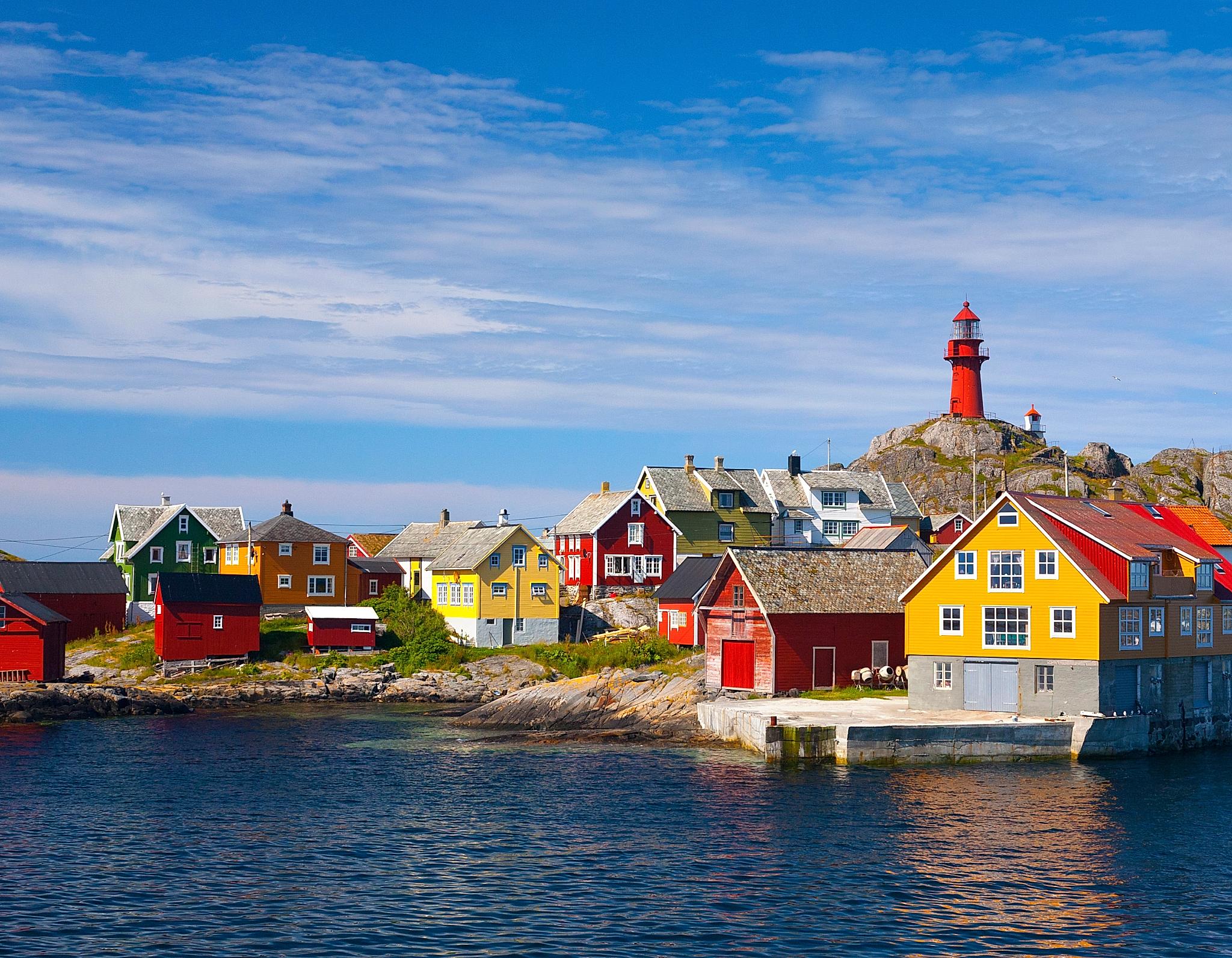 The Ona Lighthouse in Fjord Norway seen from the sea