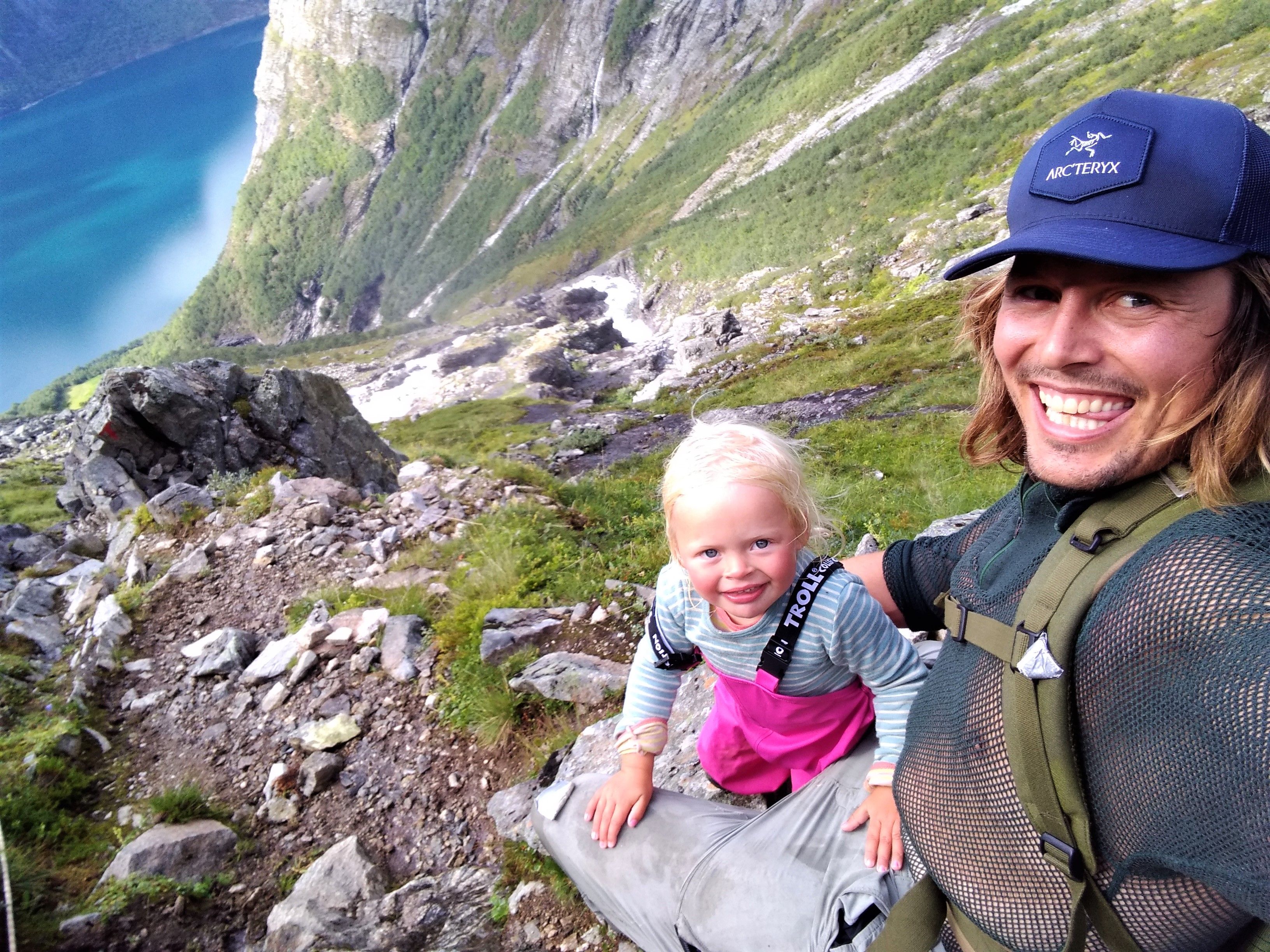 Mina and Alexander hiking up a mountain side in Øverdalen in Rauma, Fjord Norway