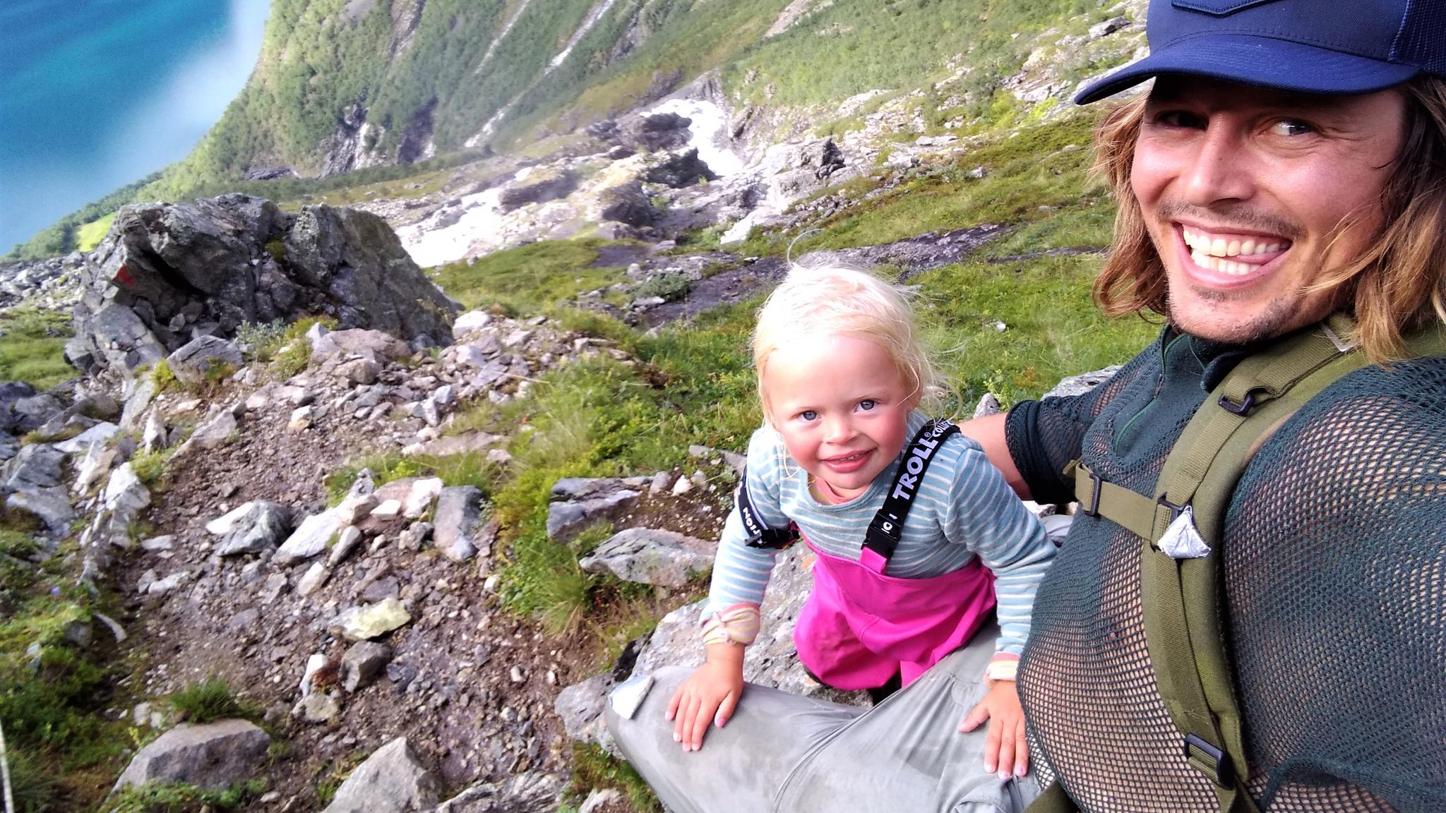 Mina and Alexander hiking up a mountain side in Øverdalen in Rauma, Fjord Norway