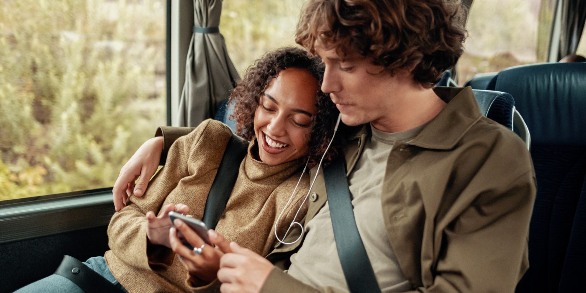 A woman and a man riding a bus in Norway.