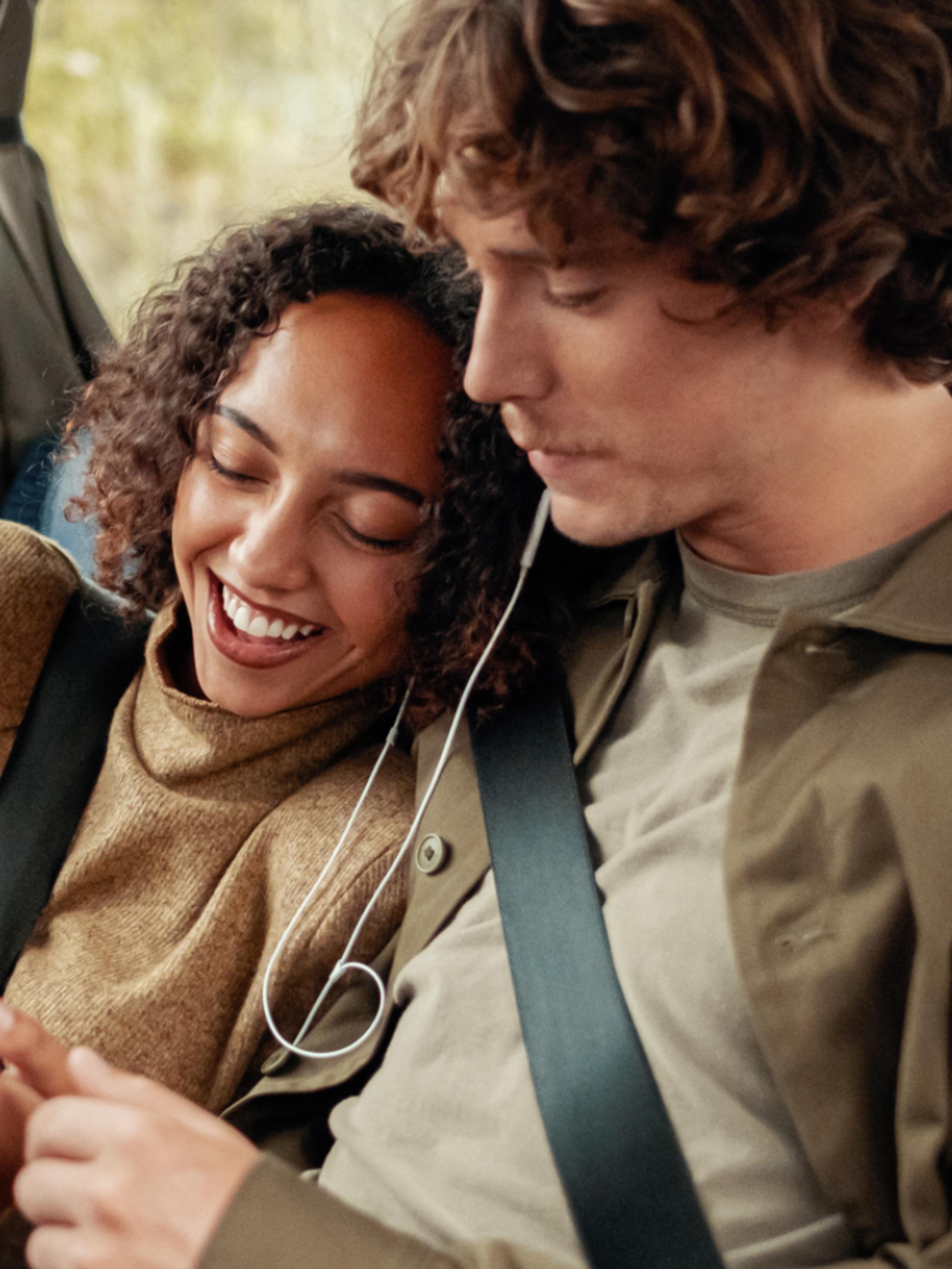 A woman and a man riding a bus in Norway.