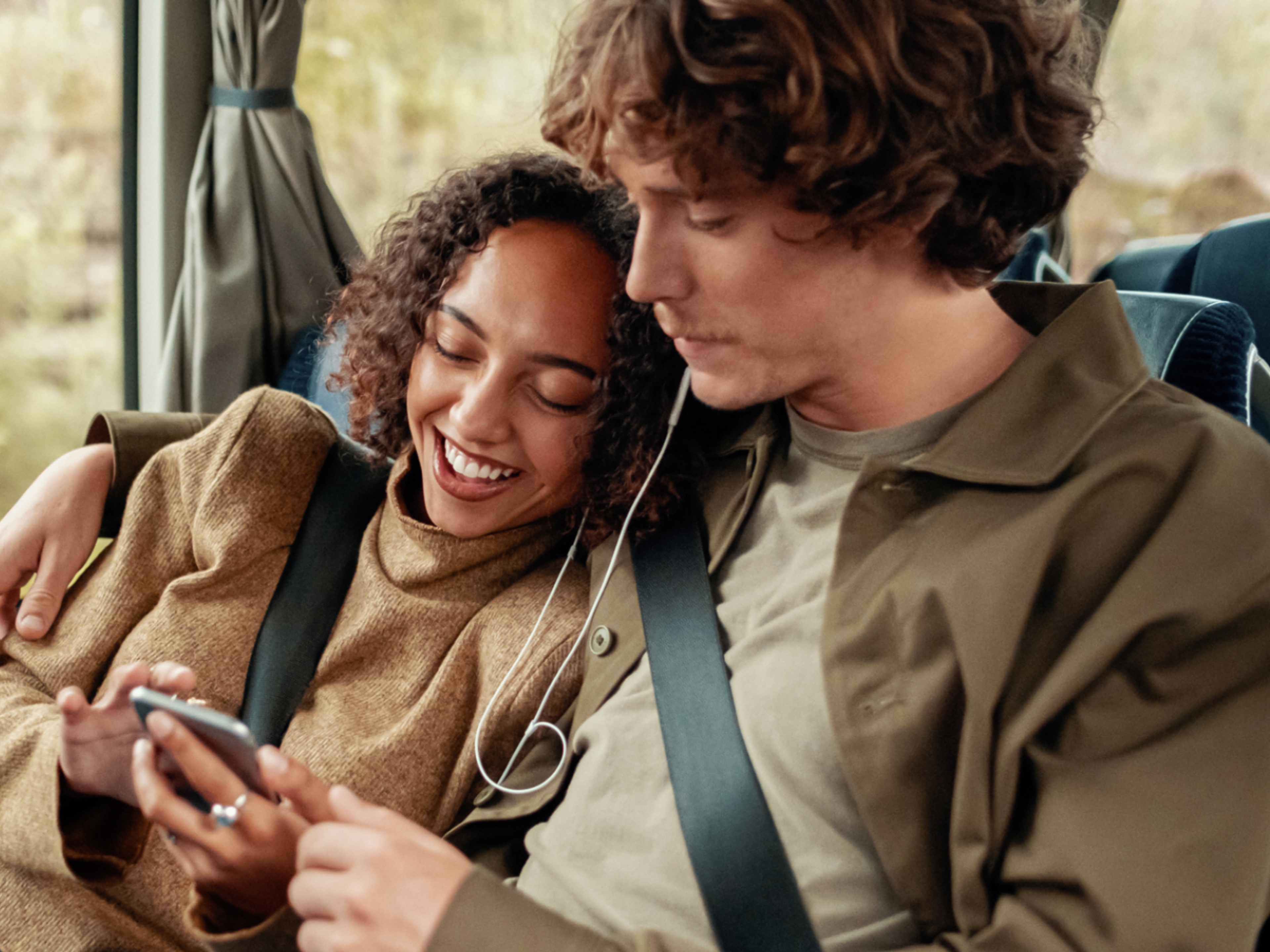 A woman and a man riding a bus in Norway.