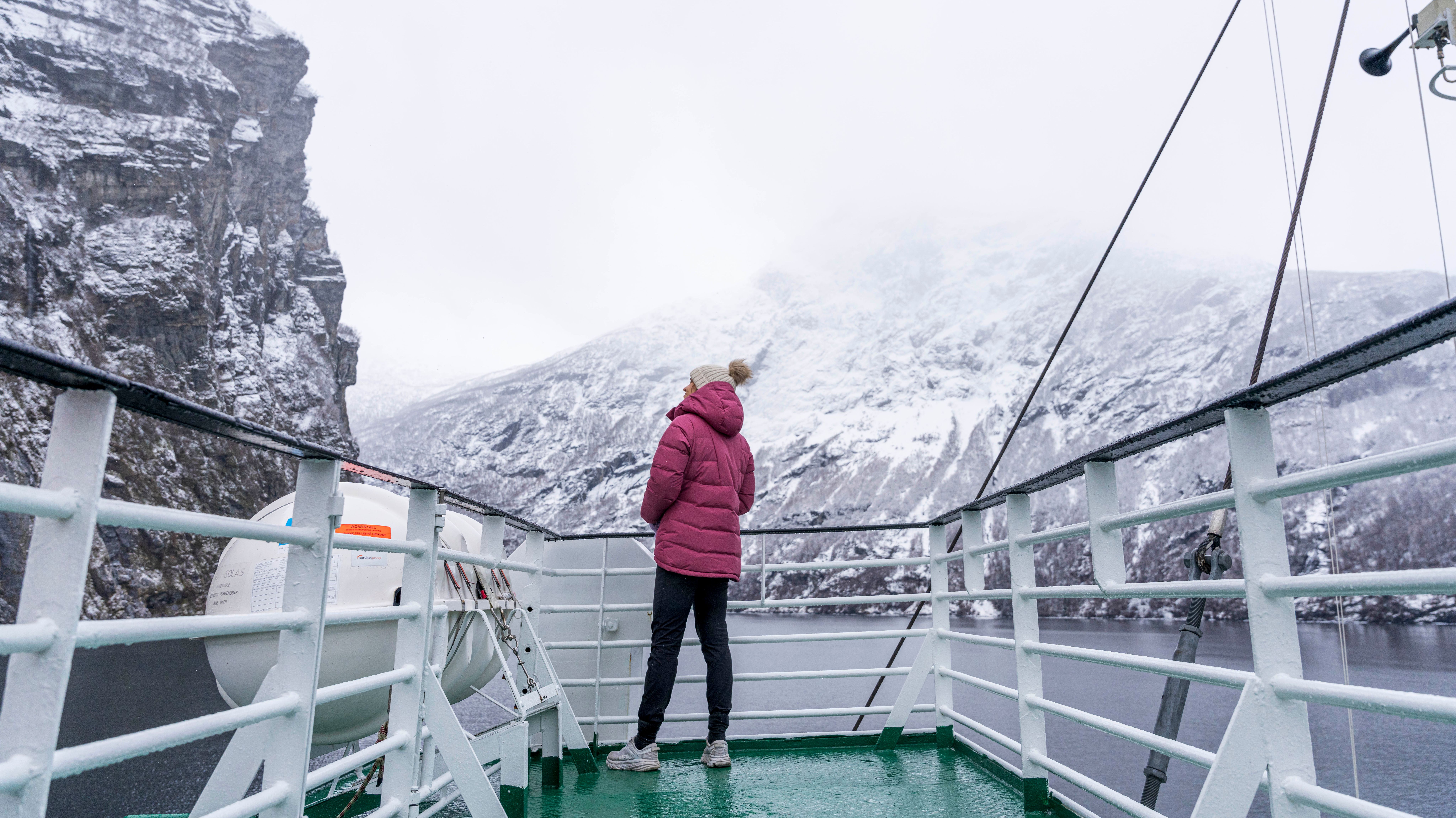 Woman enjoying the view from the car ferry, Fram, between Geiranger and Hellesylt