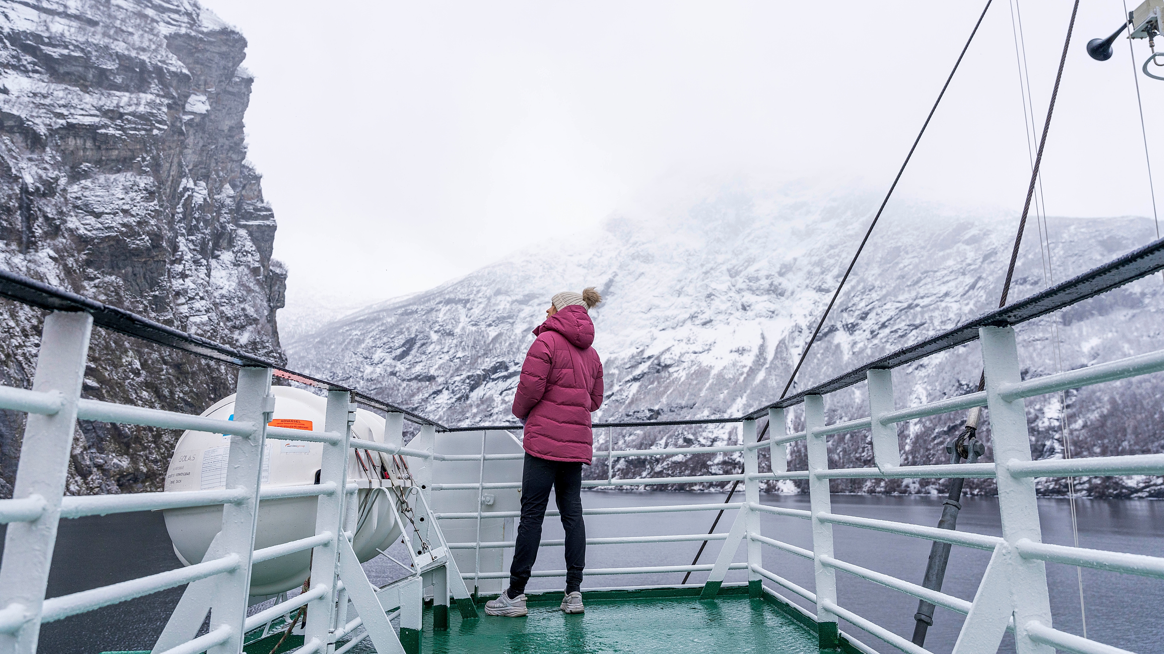 Woman enjoying the view from the car ferry, Fram, between Geiranger and Hellesylt