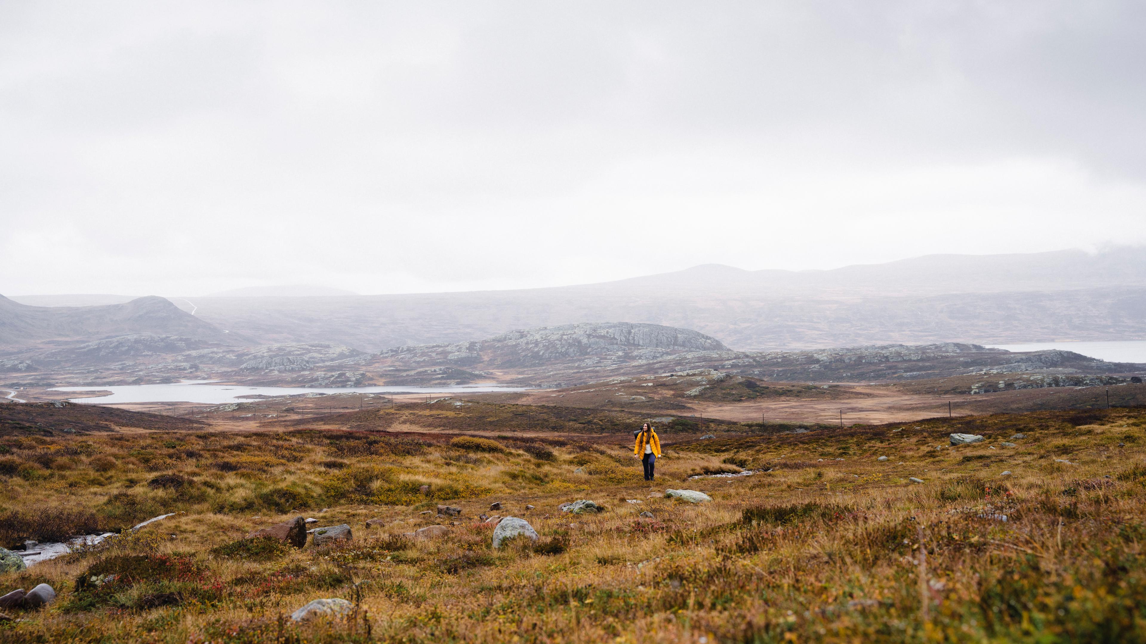 A woman hiking in the mountain in autumn.