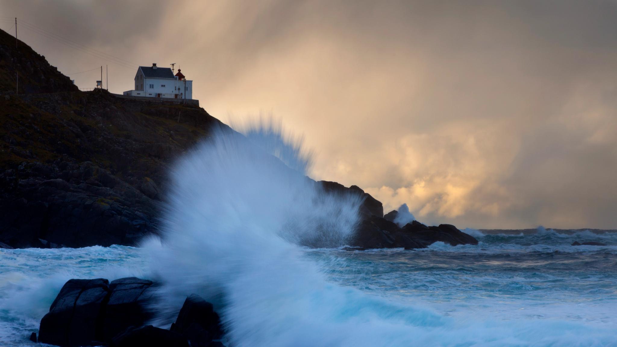 Kråknes lighthouse seen from sea view, Fjord Norway.