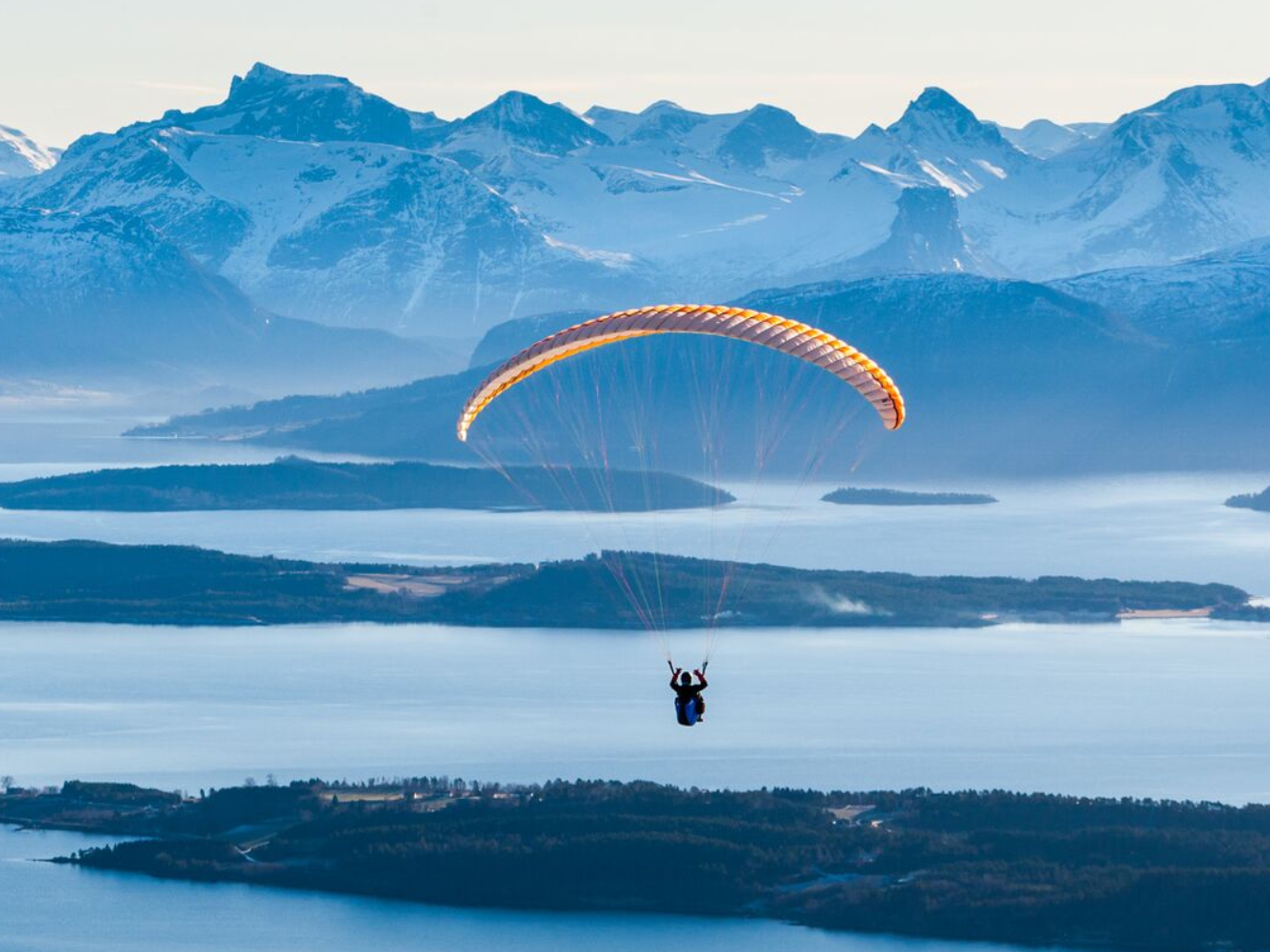 Person paragliding by Tusten in Molde, Møre og Romsdal
