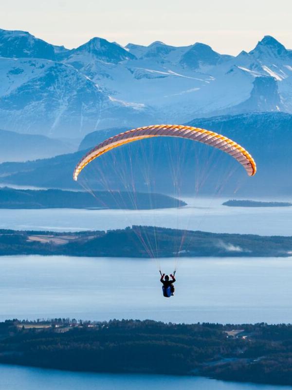 Person paragliding by Tusten in Molde, Møre og Romsdal