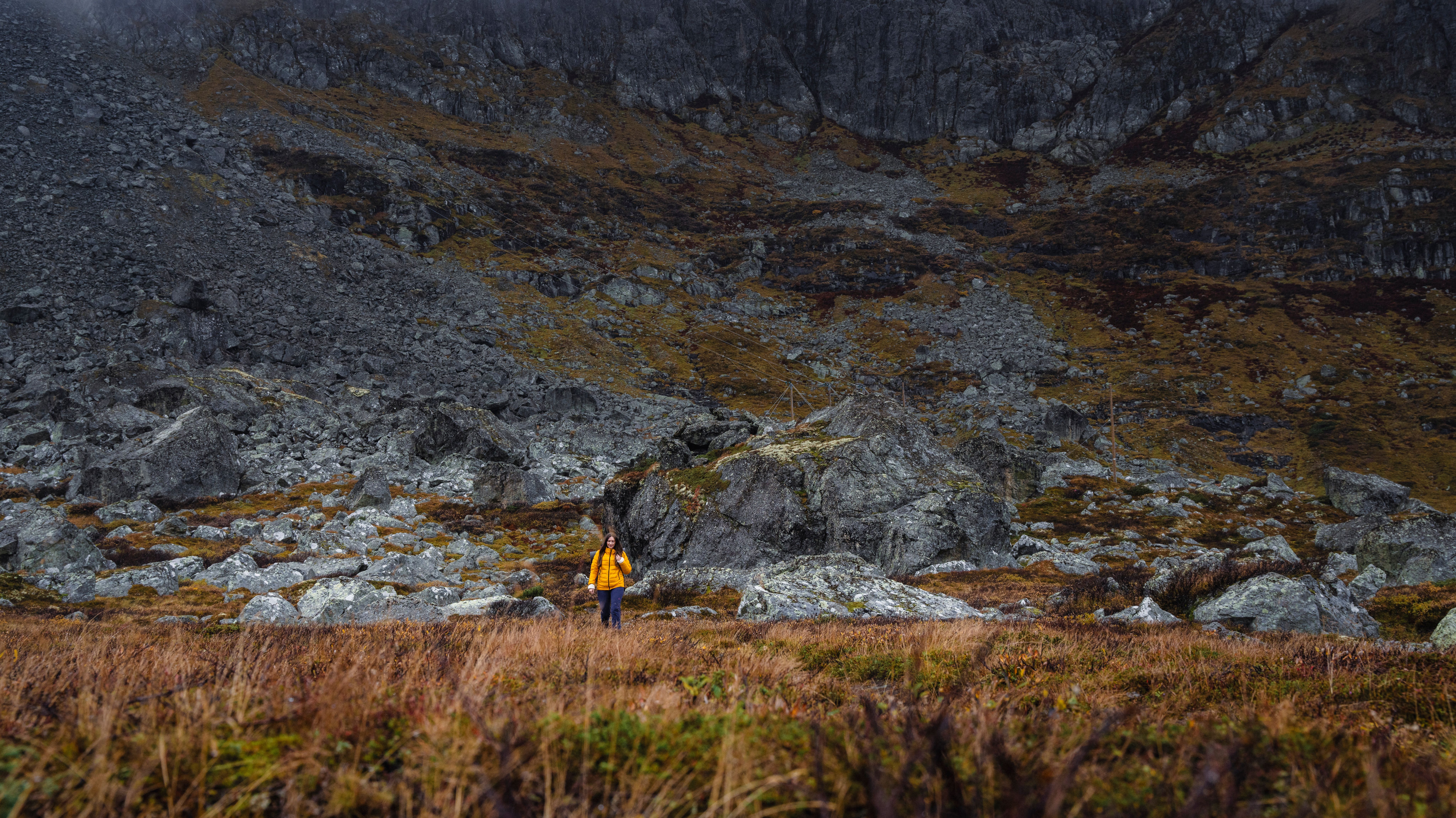A woman hiking in the mountain in autumn.