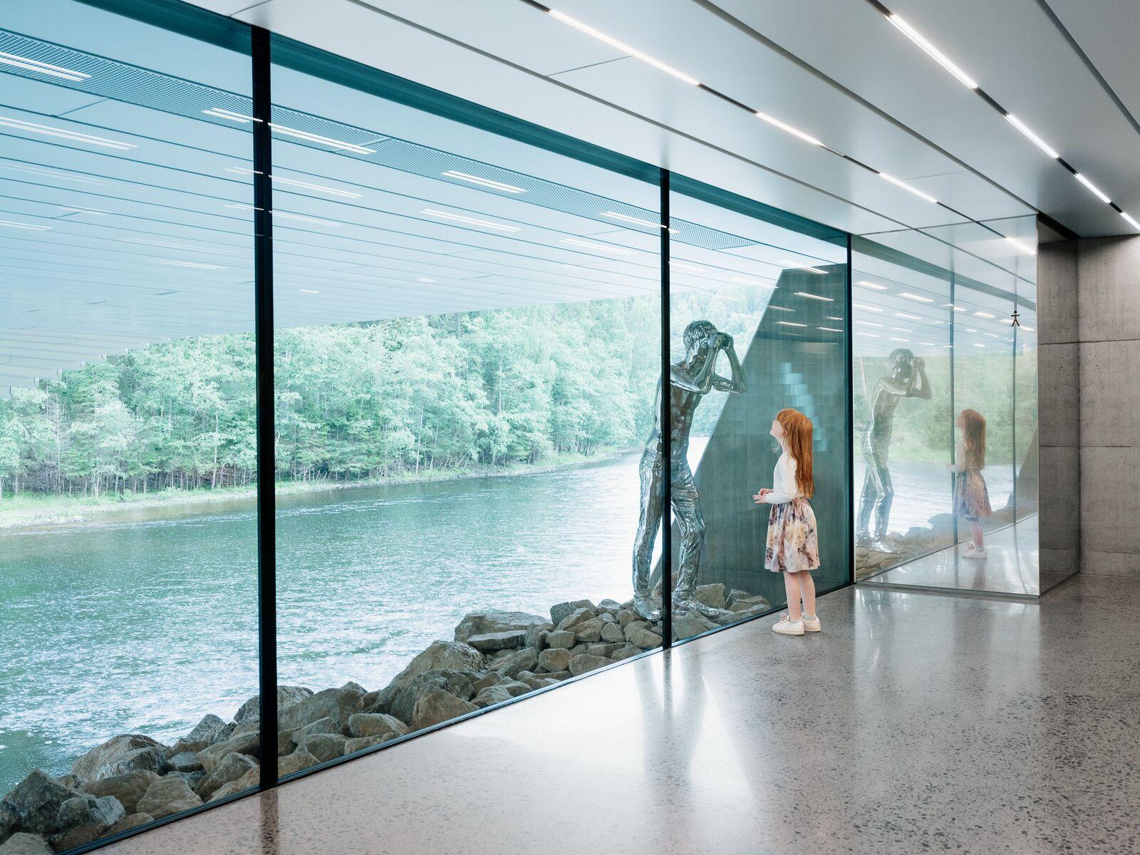 Girl looking at a silver sculpture at the Kistefos Museum in Norway