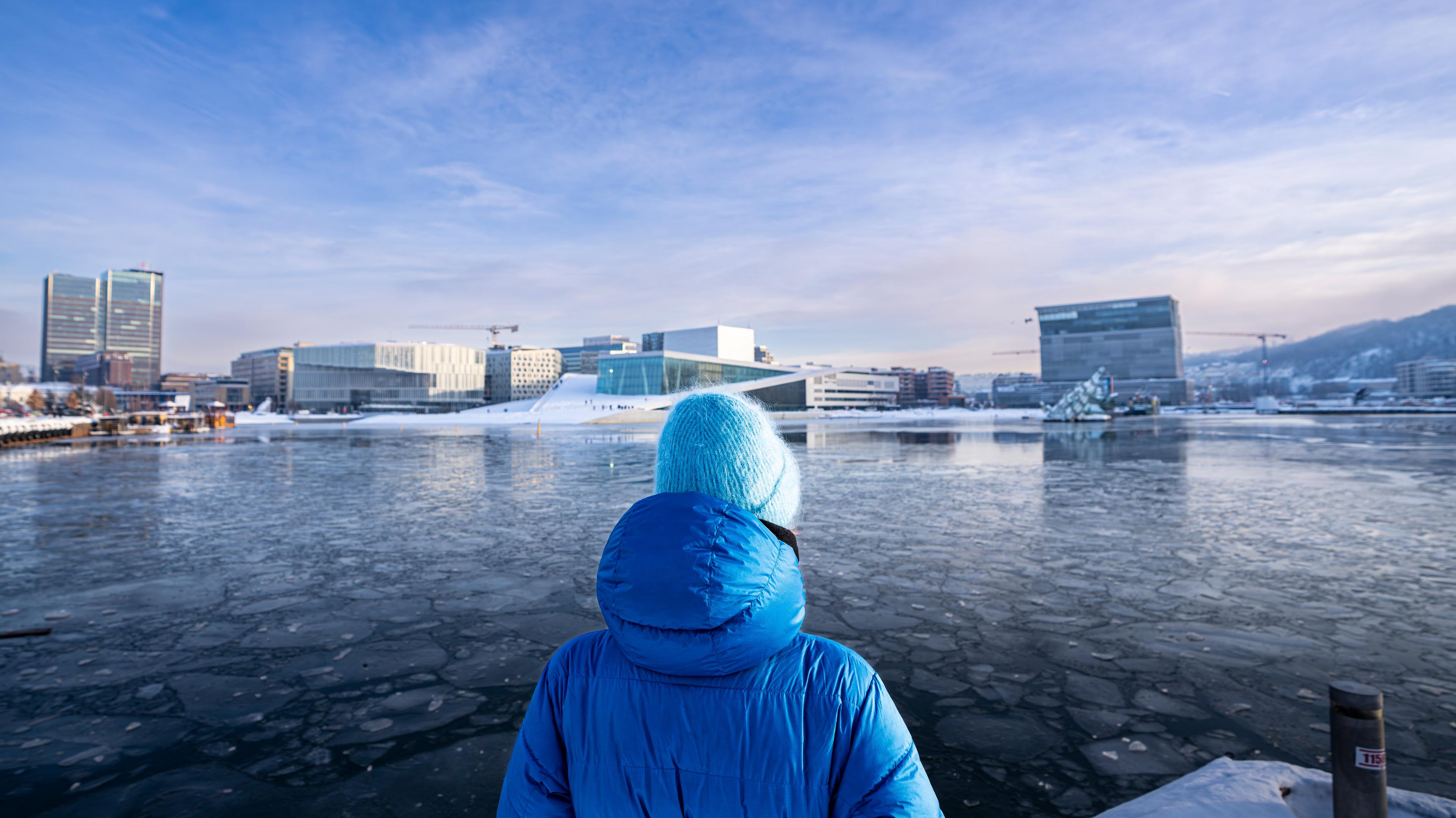 Person looking at the opera house and Munch museum in Oslo city in Eastern Norway