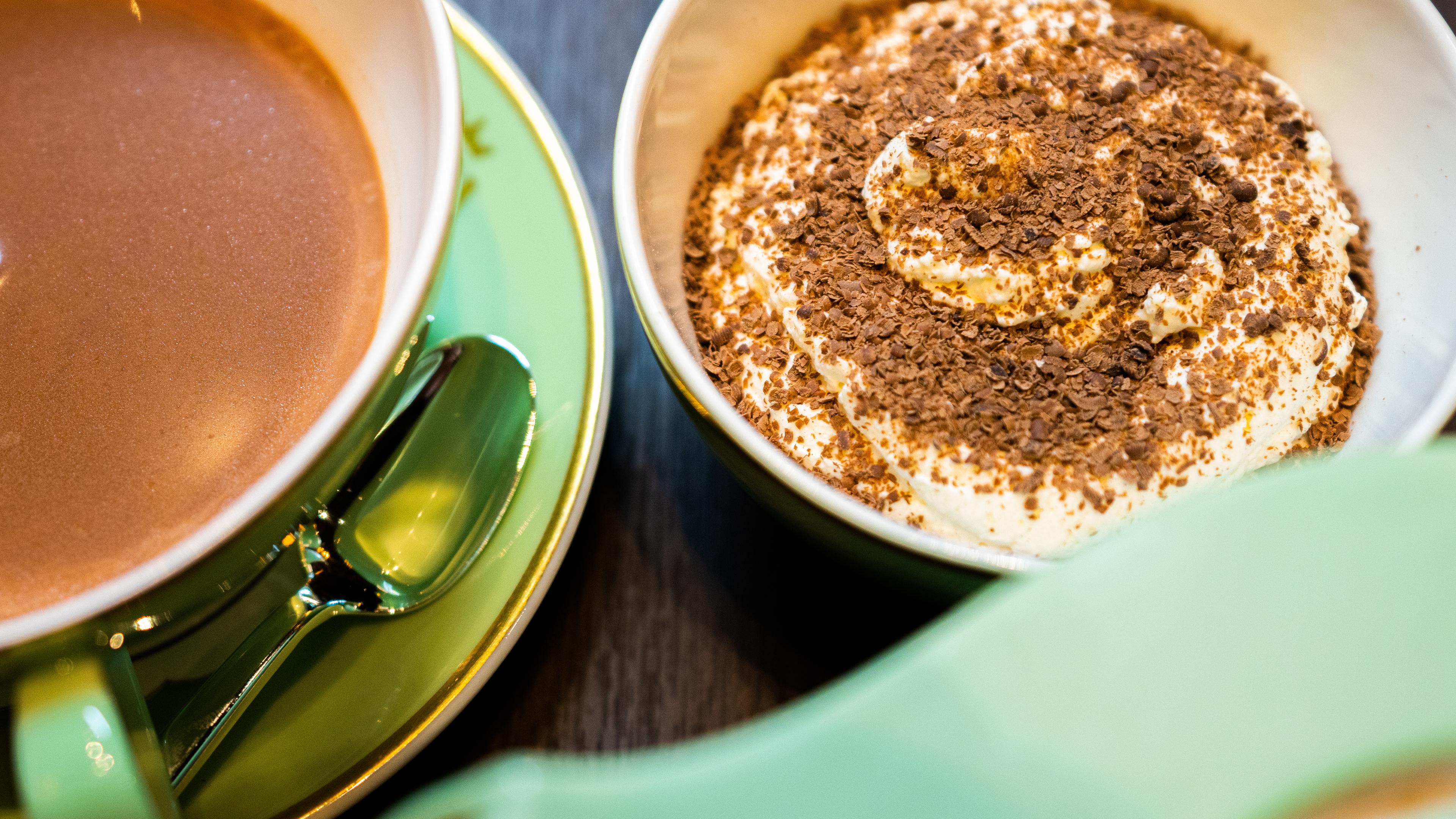 Hot chocolate and cream served on a table