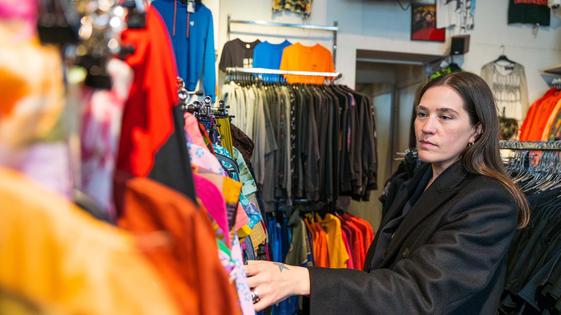Ida Elise Eide Einarsdottir looking at clothes, at Velouria Vintage in Oslo