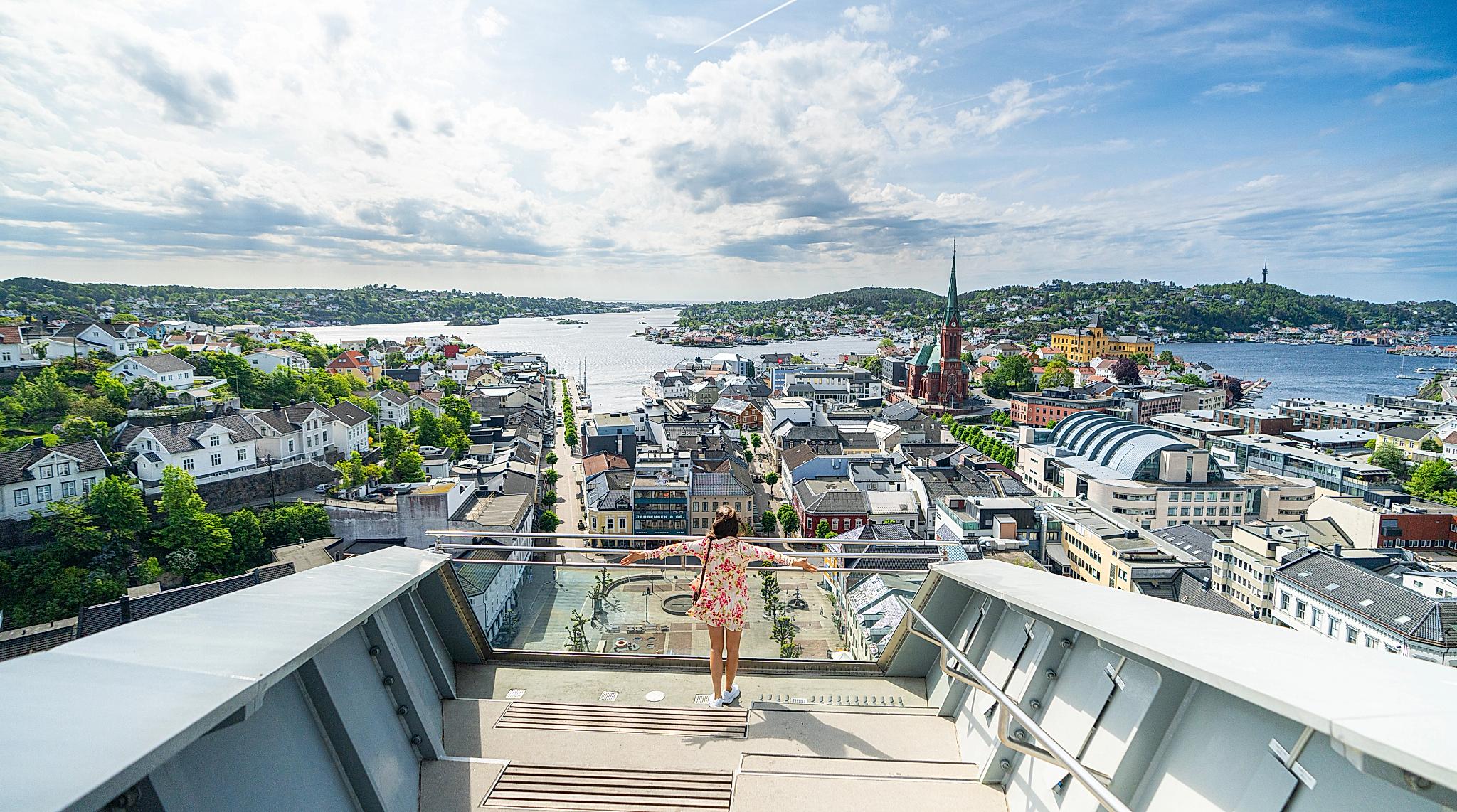A girl standing on topp of The Glass Lift in Arendal, Southern Norway