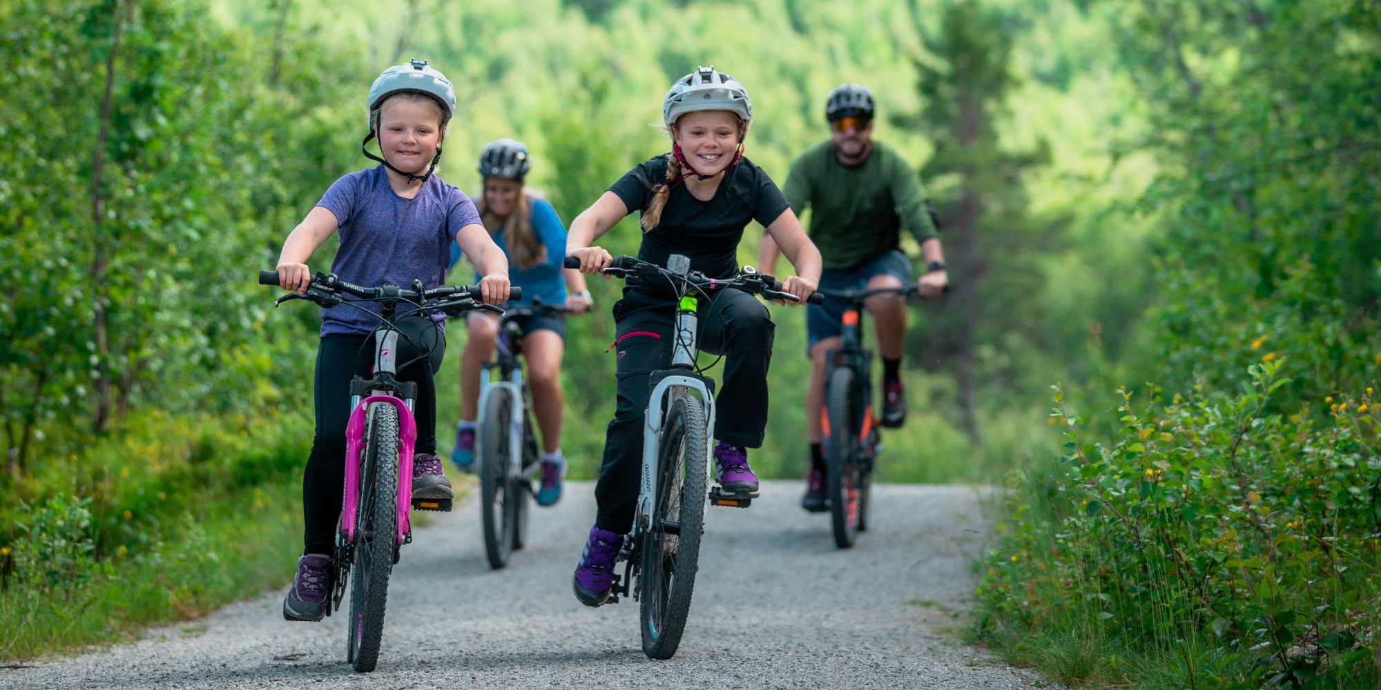 Family of four biking around Ustedalsfjorden in Geilo, Eastern Norway