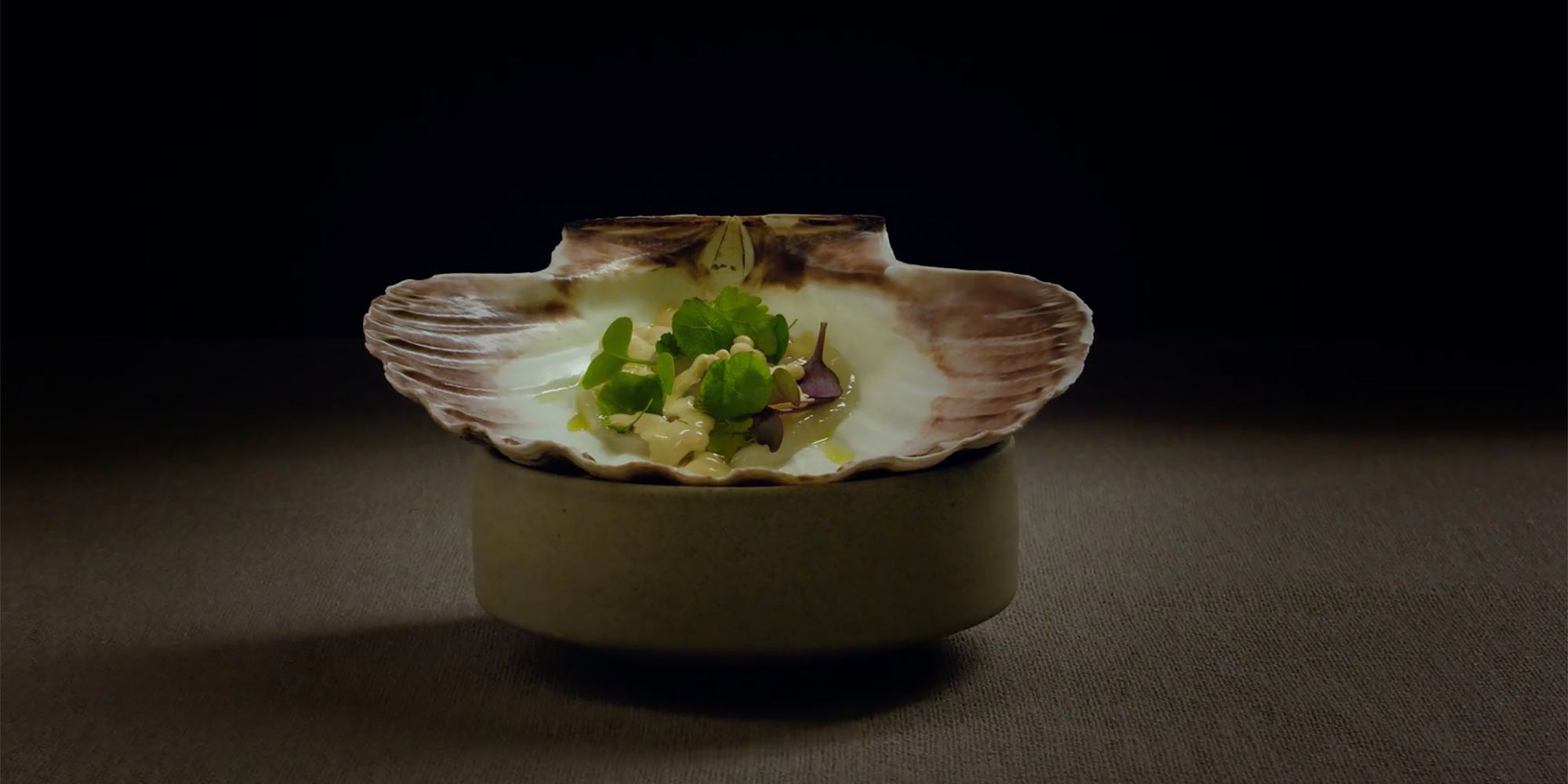 A small dish of food in a seashell at the Norwegian Michelin restaurant Fagn in Trondheim