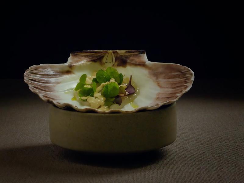 A small dish of food in a seashell at the Norwegian Michelin restaurant Fagn in Trondheim