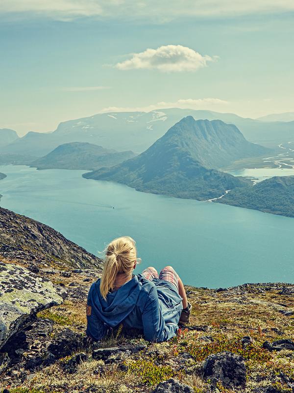 A woman enjoying the view of Lake Gjende in the Jotunheimen mountains in Eastern Norway