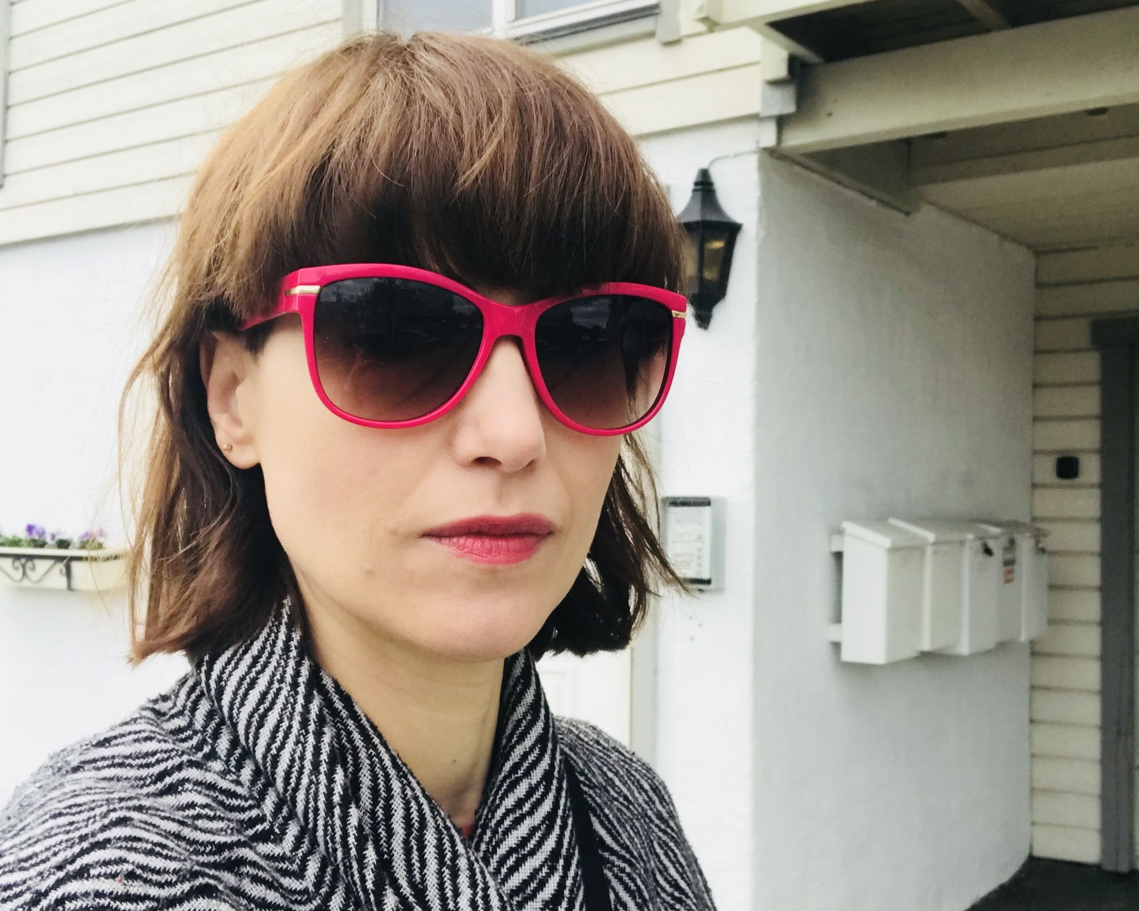 Aggie Frost with large pink sunglasses in Tromsø in Northern Norway