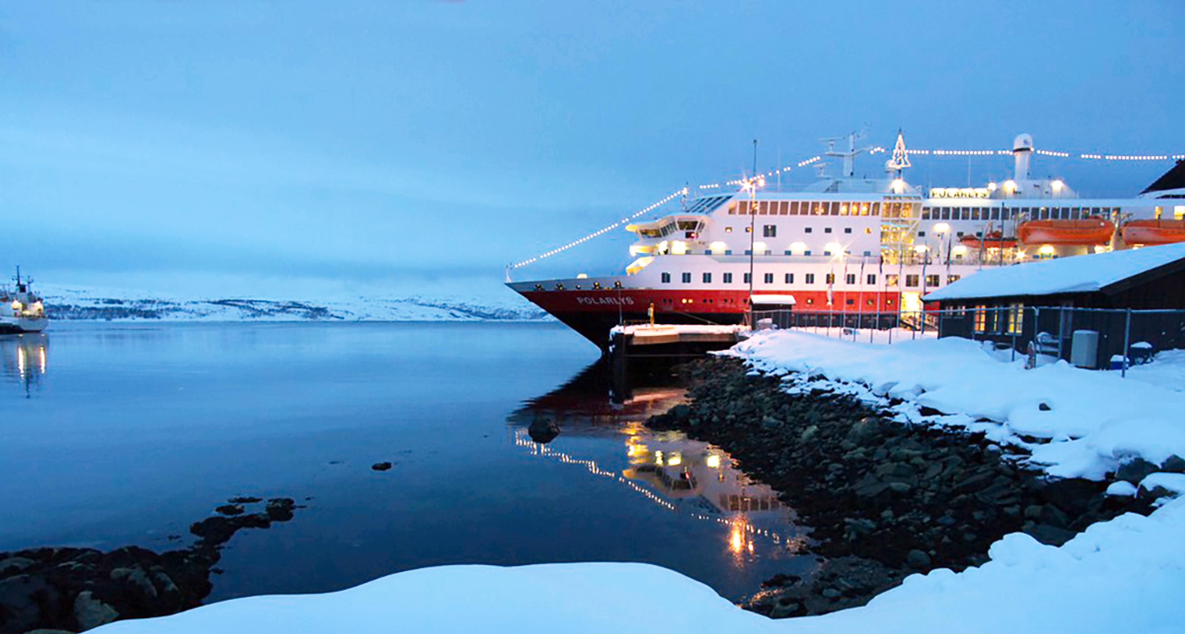 A Hurtigruten ship coverded with lights at Christmas in Kirkenes, Northern Norway