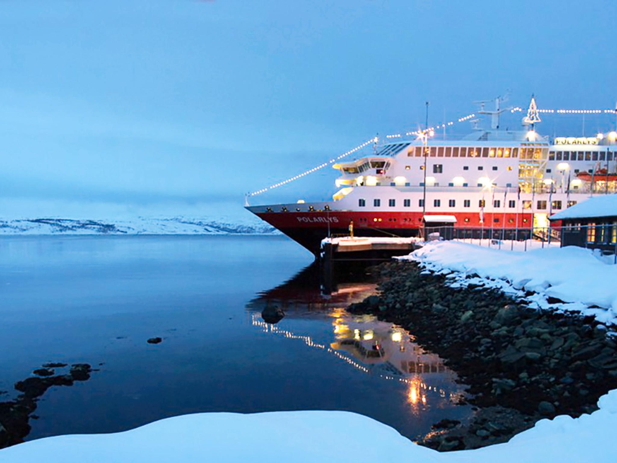 A Hurtigruten ship coverded with lights at Christmas in Kirkenes, Northern Norway